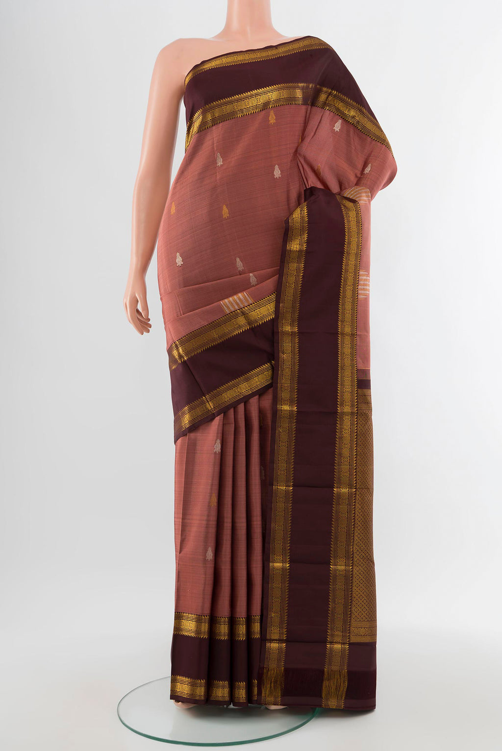 Pure Silk Pure Zari Bronze Kanjivaram Saree with Zari Butta on the body and Silk Border.  displayed on a mannequin