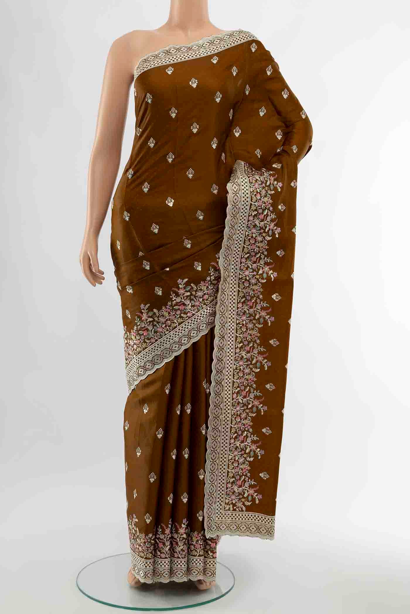 Bronze Art Silk Saree with Embroidery on the body and Fancy Border displayed on a mannequin