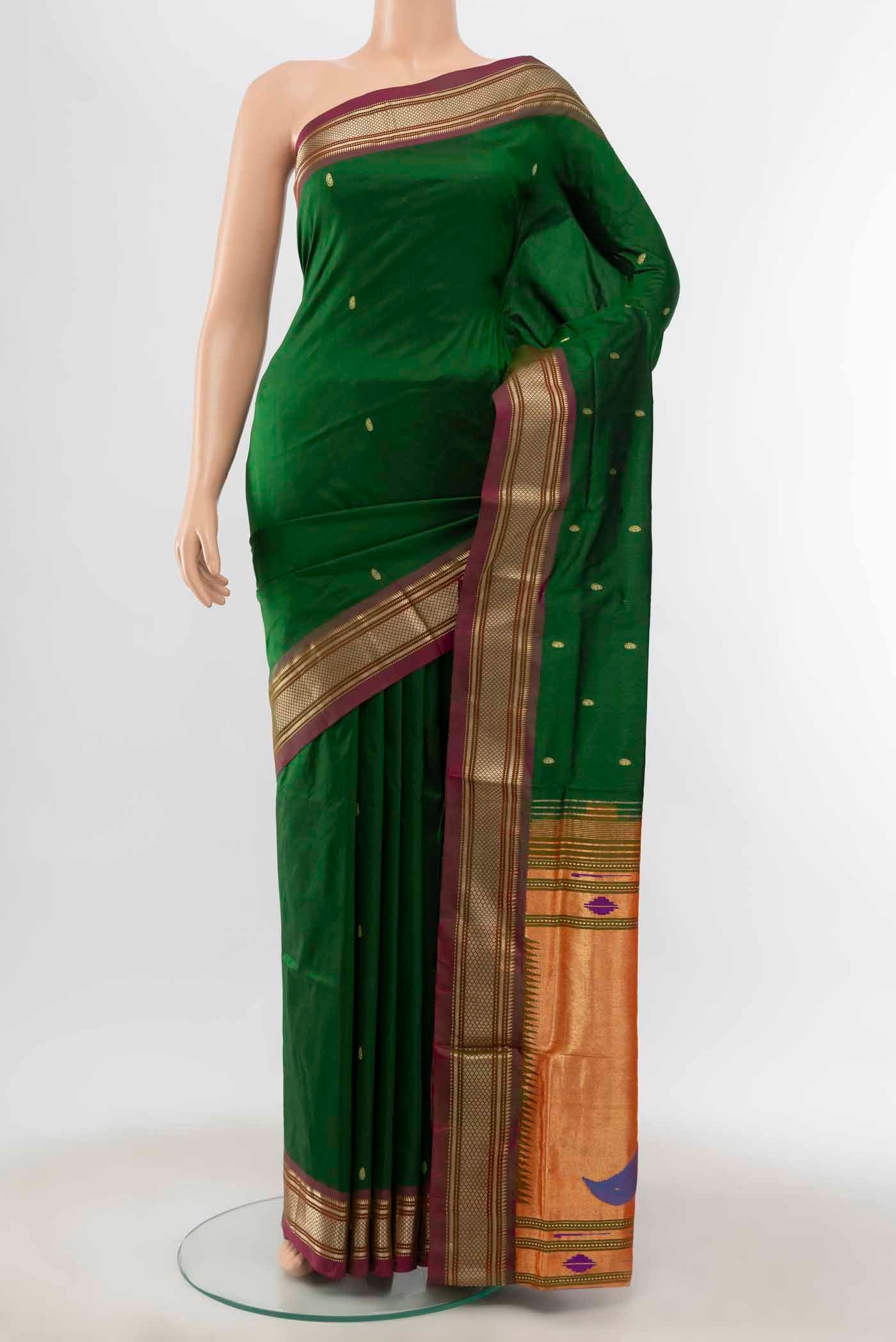 Bottle Green Paithani Silk Saree with Zari Butta on the body and Silk Border displayed on a mannequin
