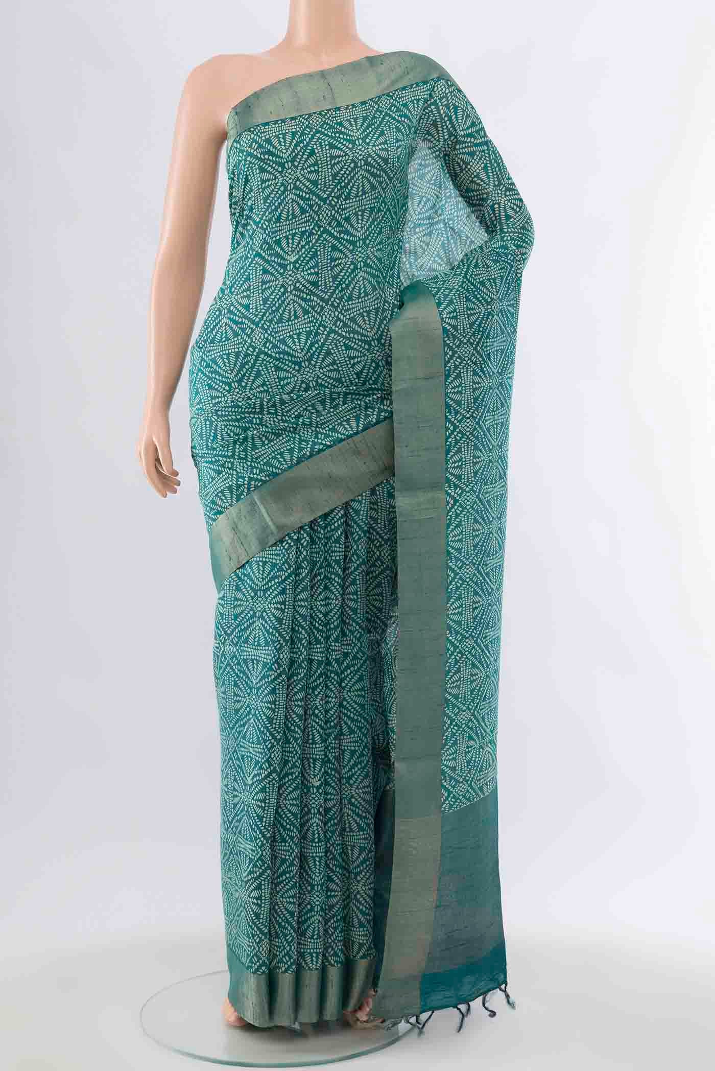Blue Tussar Silk Saree with Printed design on the body and Zari Border displayed on a mannequin