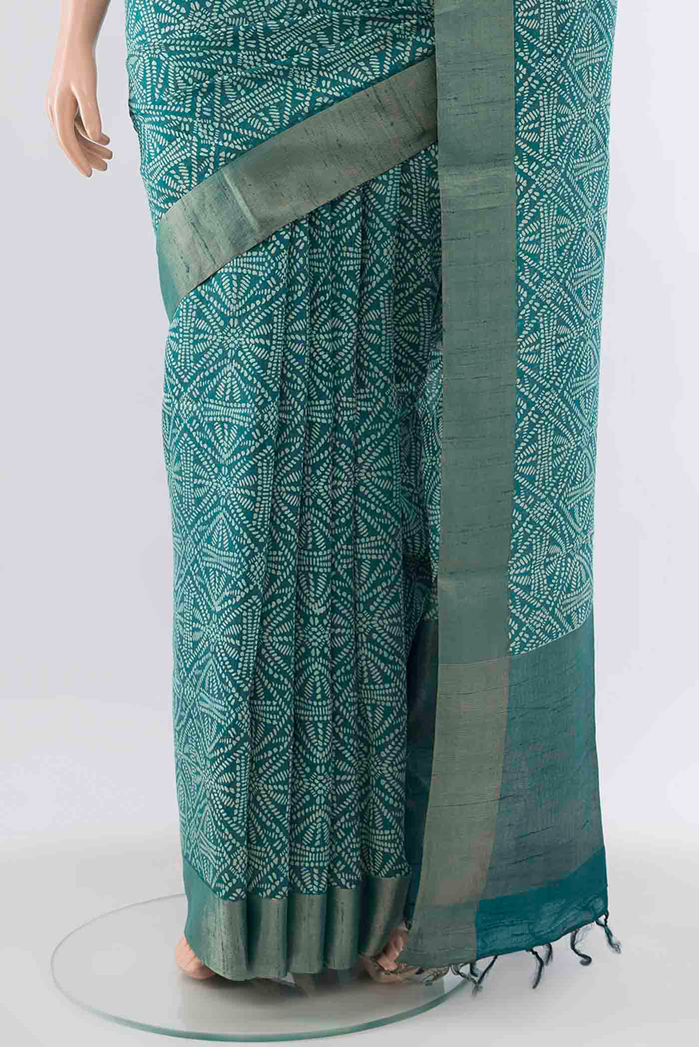 Pleats and pallu of Blue Tussar Silk Saree with Printed design on the body and Zari Border