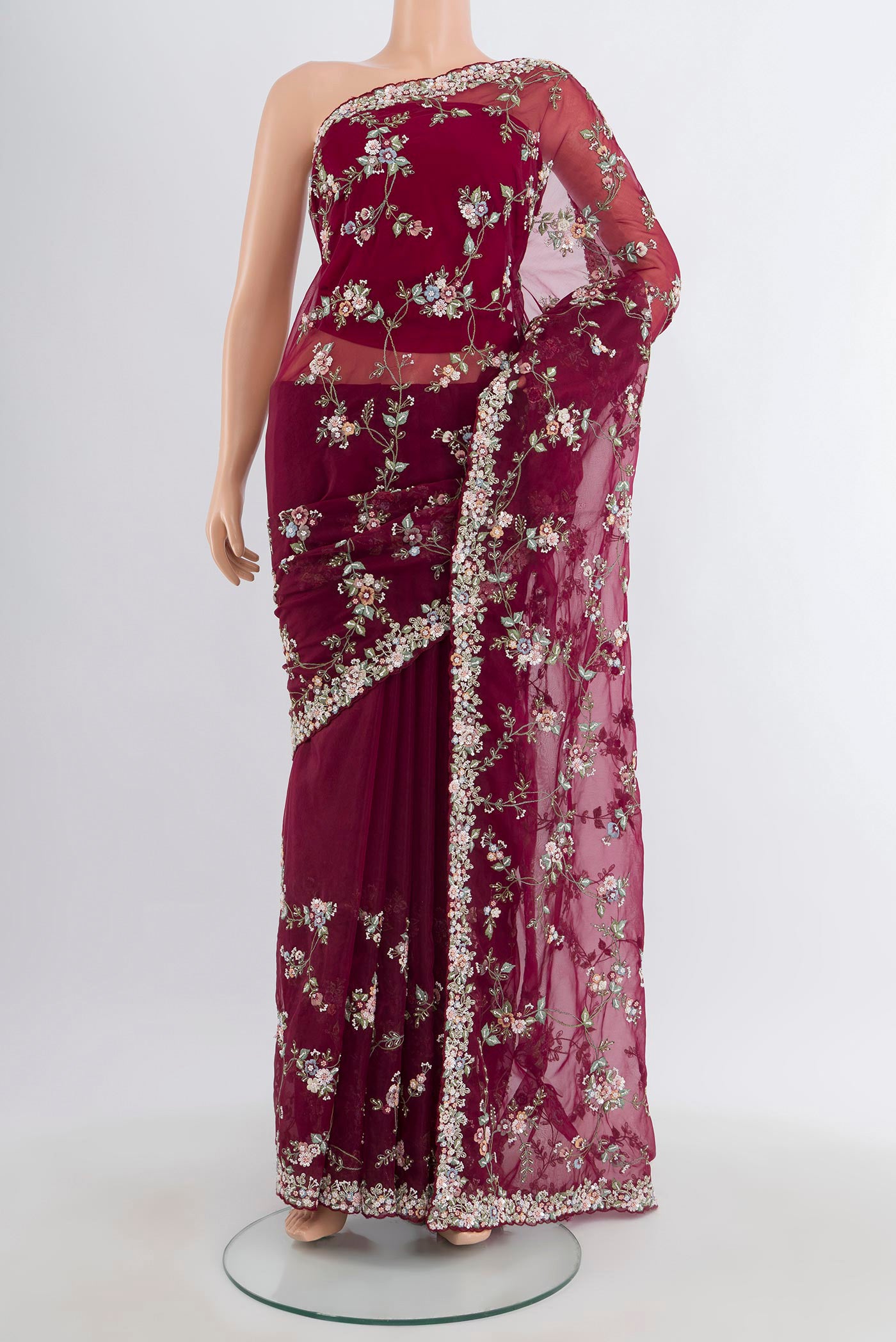 Maroon Embroidery Net Saree with Embroidery on the body and Embroidery Border.  displayed on a mannequin
