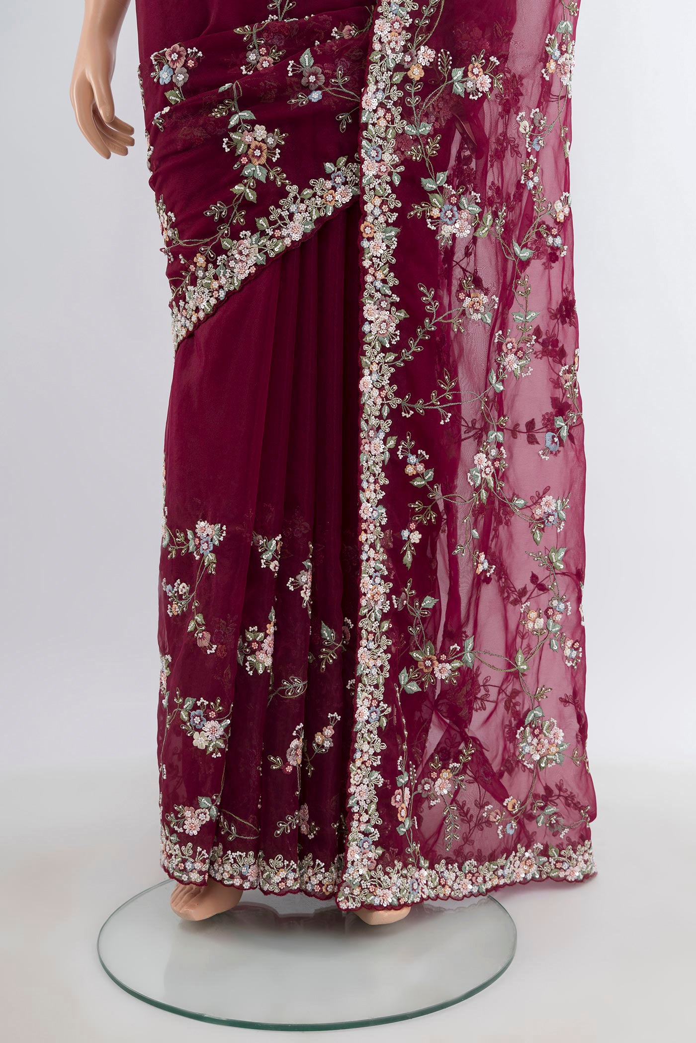 Pleats and pallu of Maroon Embroidery Net Saree with Embroidery on the body and Embroidery Border. 