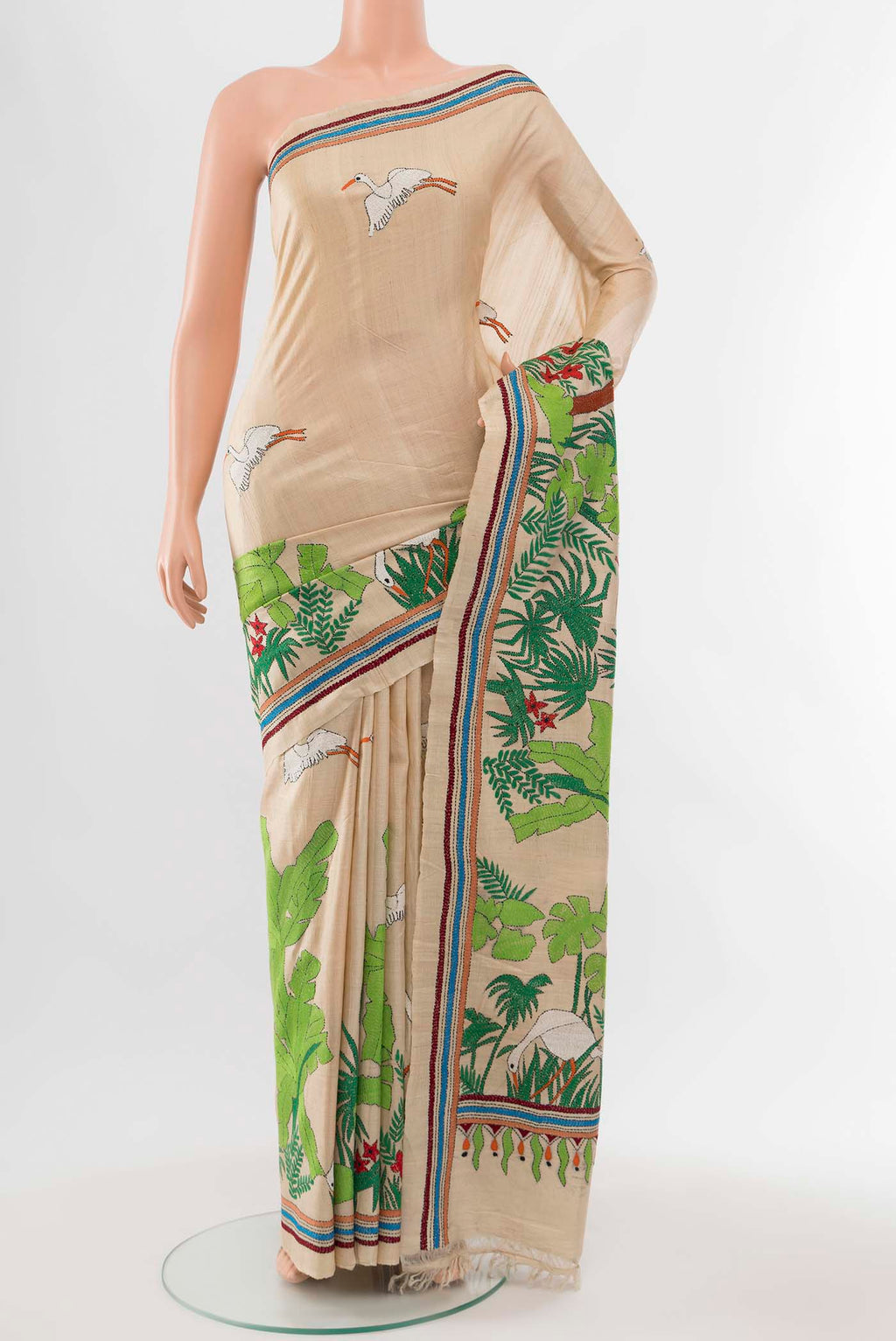 Cream Tussar Silk Saree with Embroidery on the body and Silk Border displayed on a mannequin