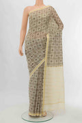 Beige Tussar Silk Saree with Zari Butta on the body and Silk Border displayed on a mannequin