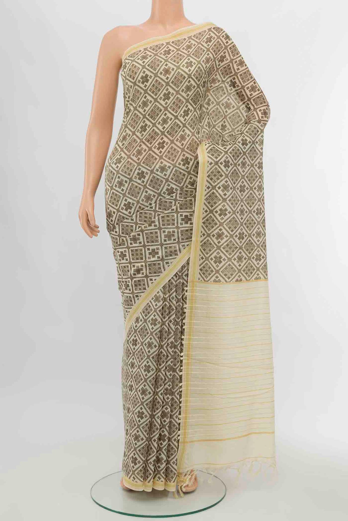 Beige Tussar Silk Saree with Zari Butta on the body and Silk Border displayed on a mannequin