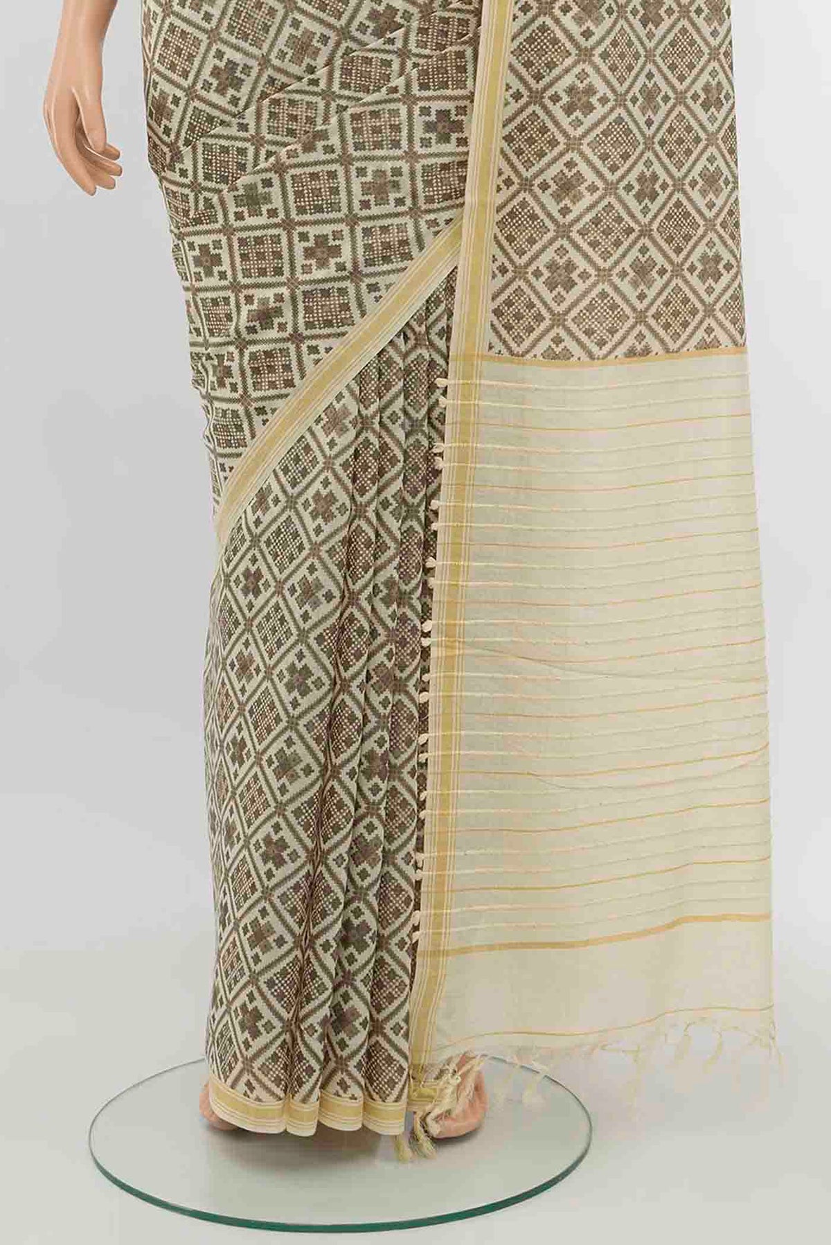Pleats and pallu of Beige Tussar Silk Saree with Zari Butta on the body and Silk Border