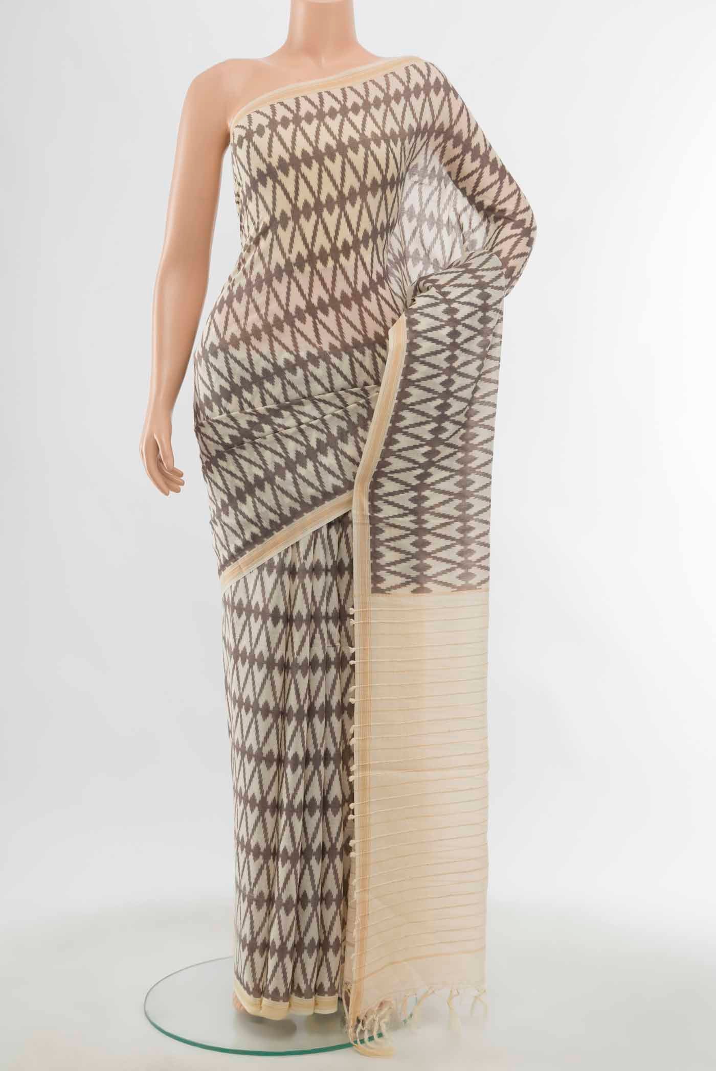 Cream Maheshwari Silk Cotton Saree with Floral Print on the body and Silk Border displayed on a mannequin