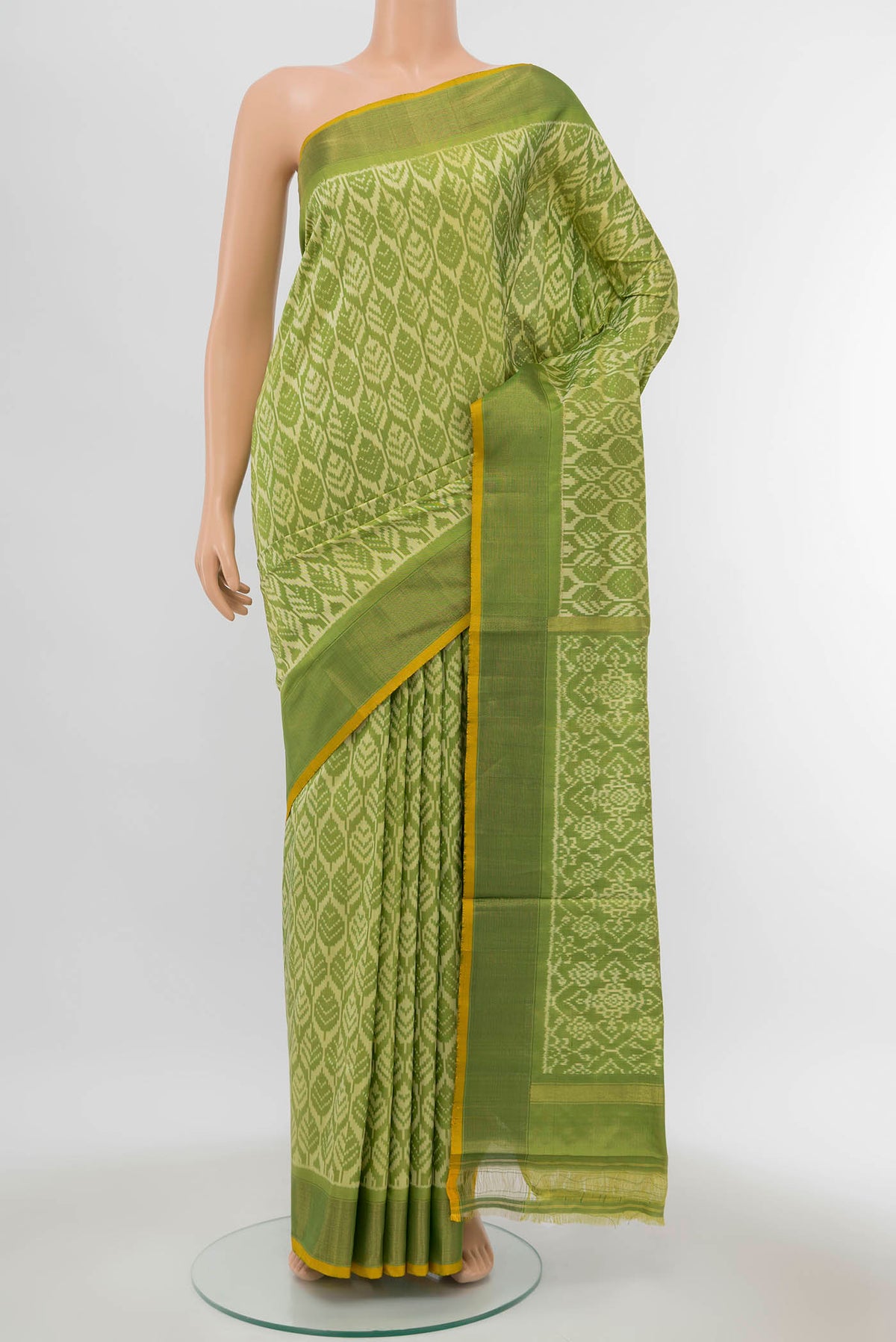 Green Pochampally Silk Saree with Ikat Print on the body and Zari Border displayed on a mannequin
