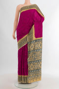 Magenta Bandhani Silk Saree with Bandhani on the body and Printed Border.  displayed on a mannequin