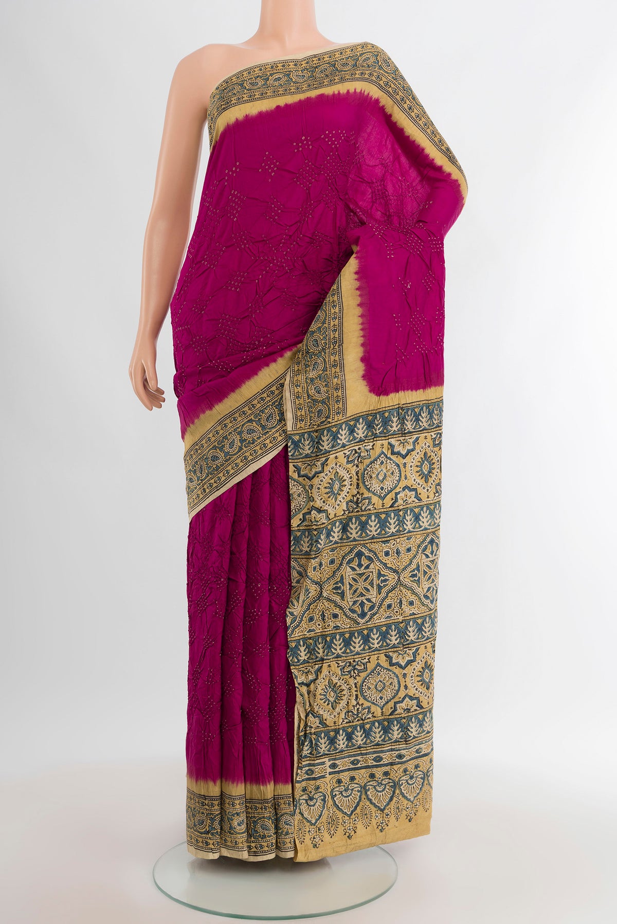 Magenta Bandhani Silk Saree with Bandhani on the body and Printed Border.  displayed on a mannequin