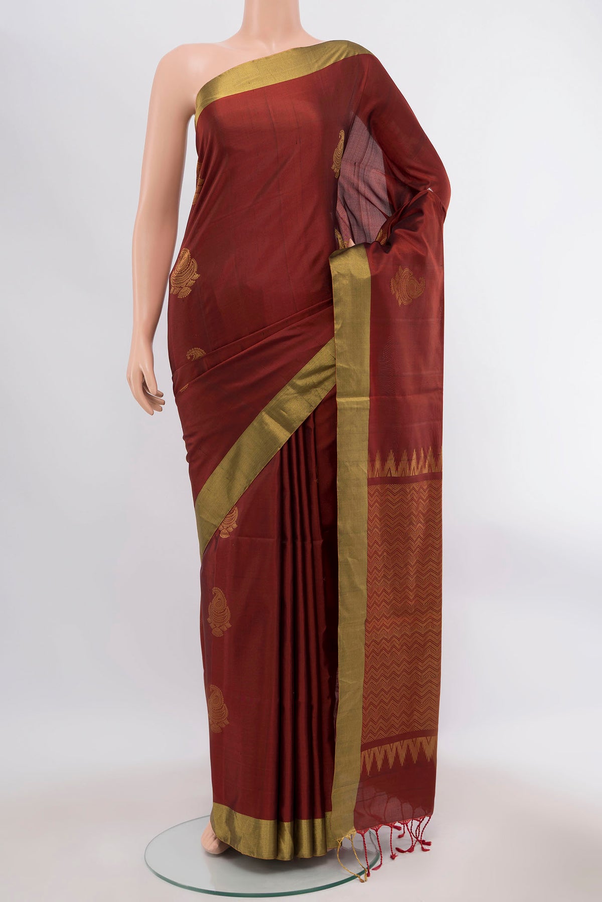 Brown Soft Silk Saree with Zari Butta on the body and Zari Border displayed on a mannequin