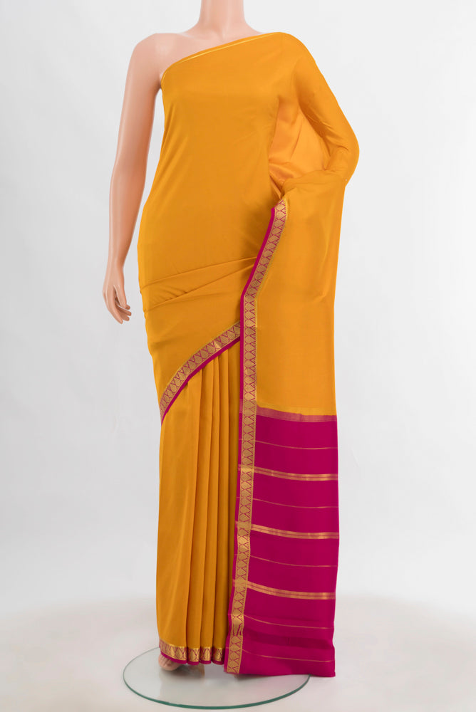 Yellow Mysore Crepe Saree with Plain Body and Silk Border.  displayed on a mannequin
