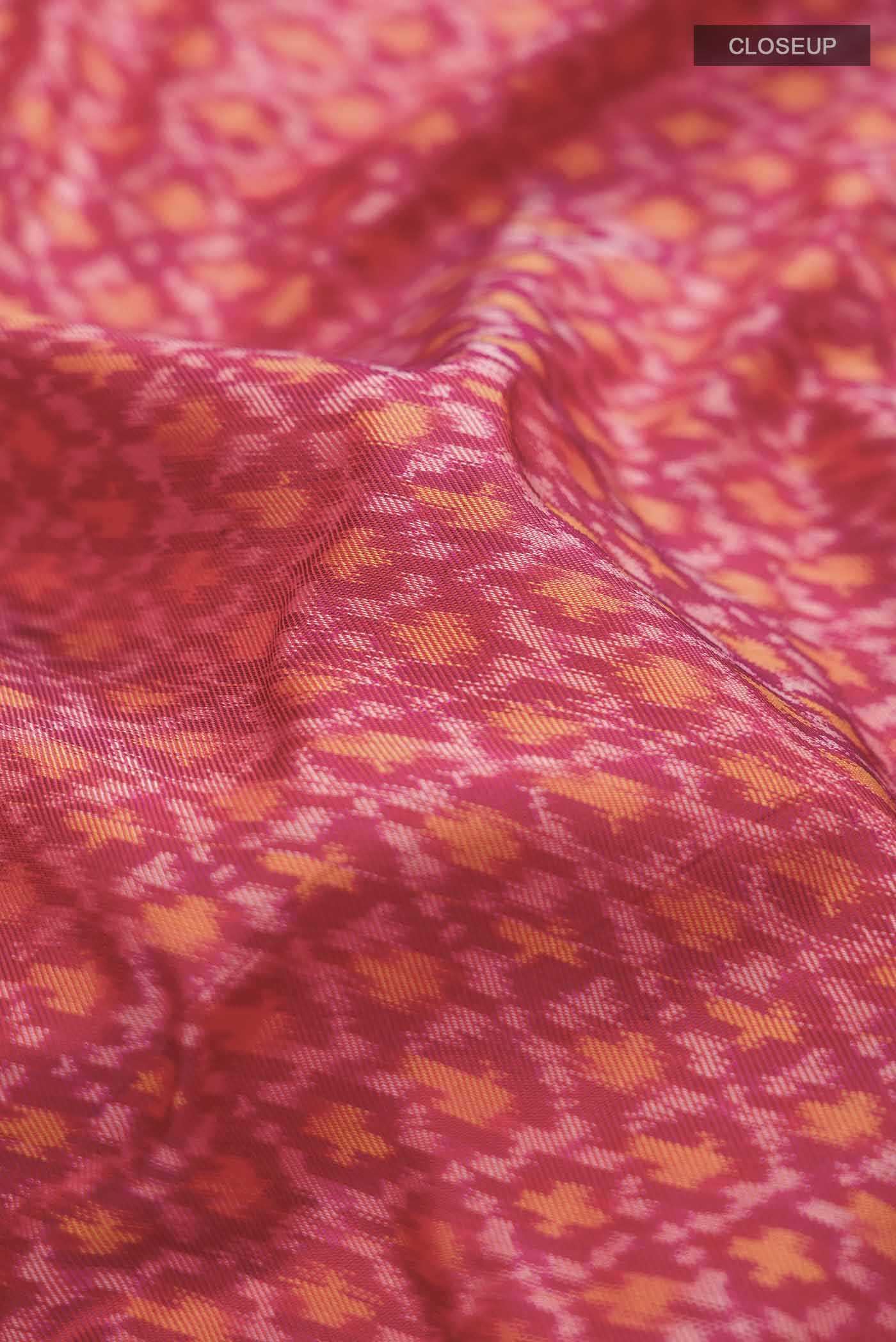 Close up of Red Rajkot Patola Silk Saree with Pure Ikat on the body and Plain Border displaying folds
