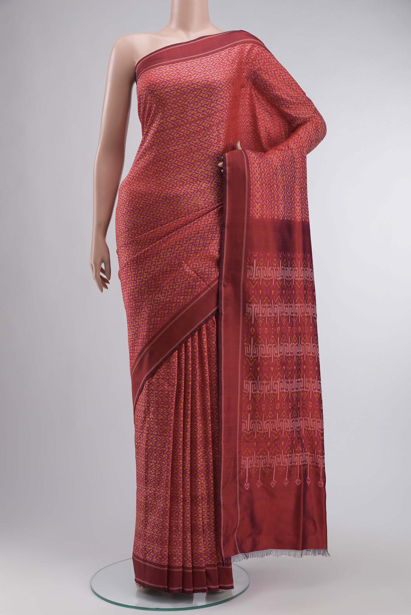 Red Rajkot Patola Silk Saree with Pure Ikat on the body and Plain Border displayed on a mannequin