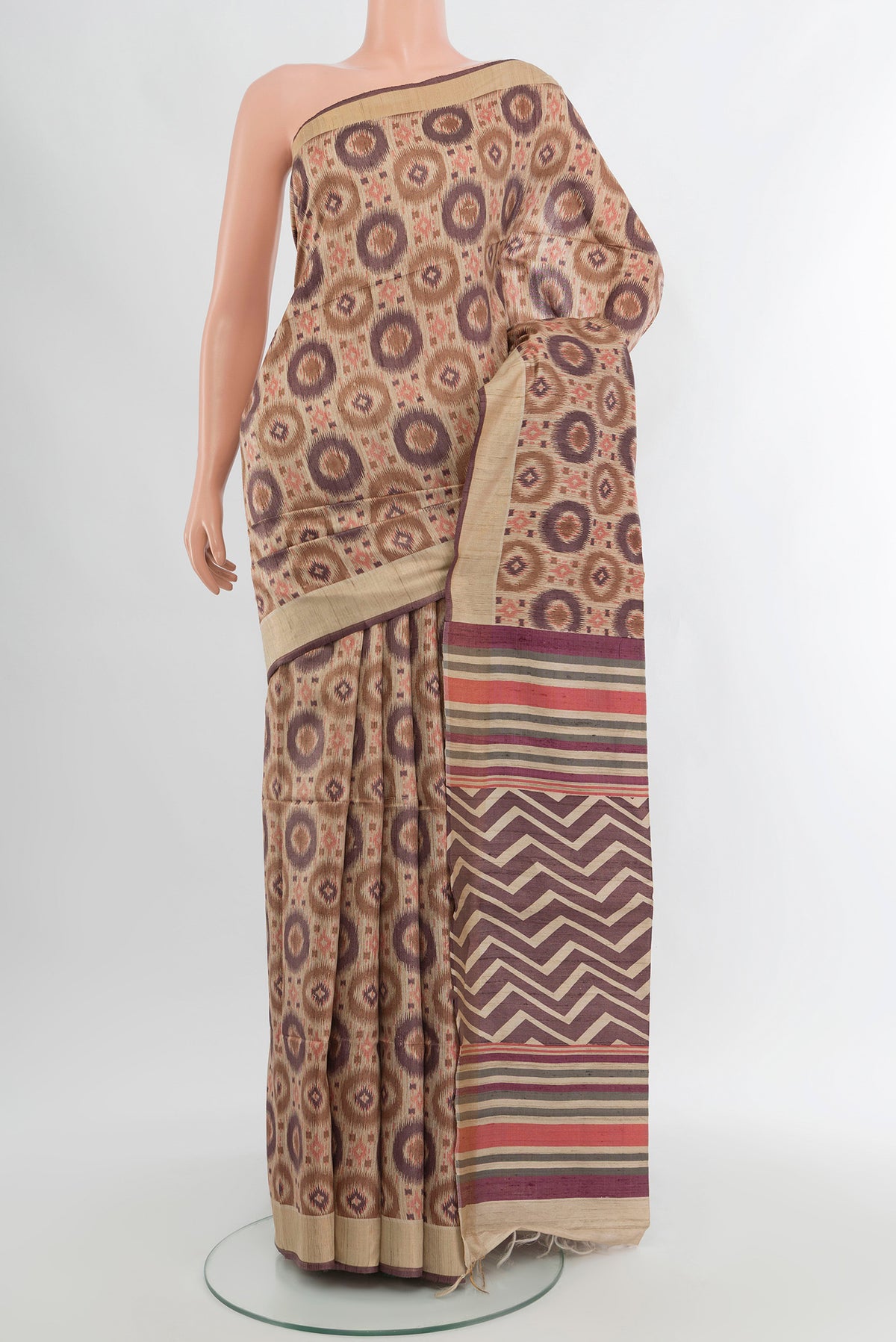Beige Tussar Silk Saree with Floral Print on the body and Zari Border.  displayed on a mannequin