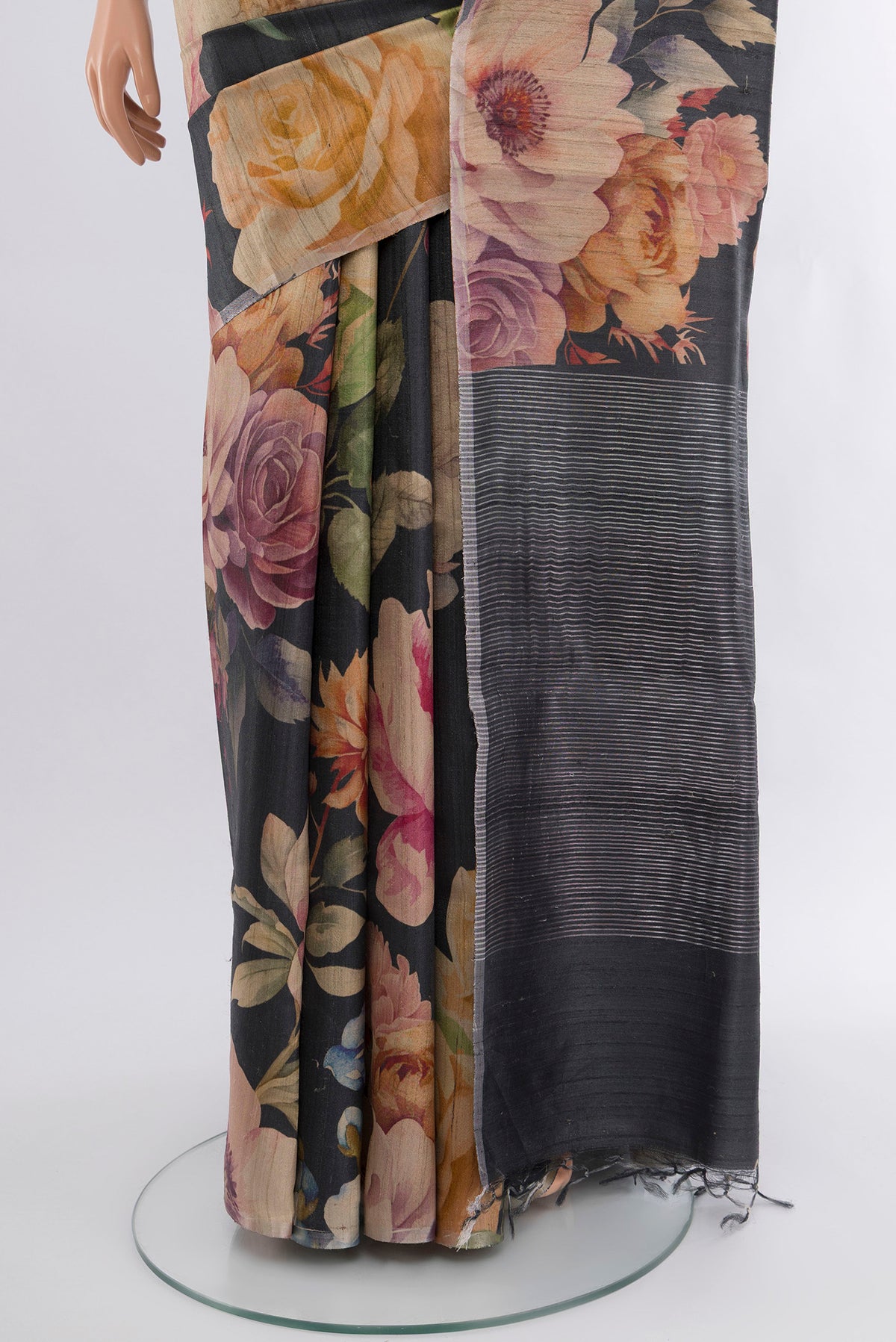 Pleats and pallu of Black Tussar Silk Saree with Floral Print on the body and Zari Border. 