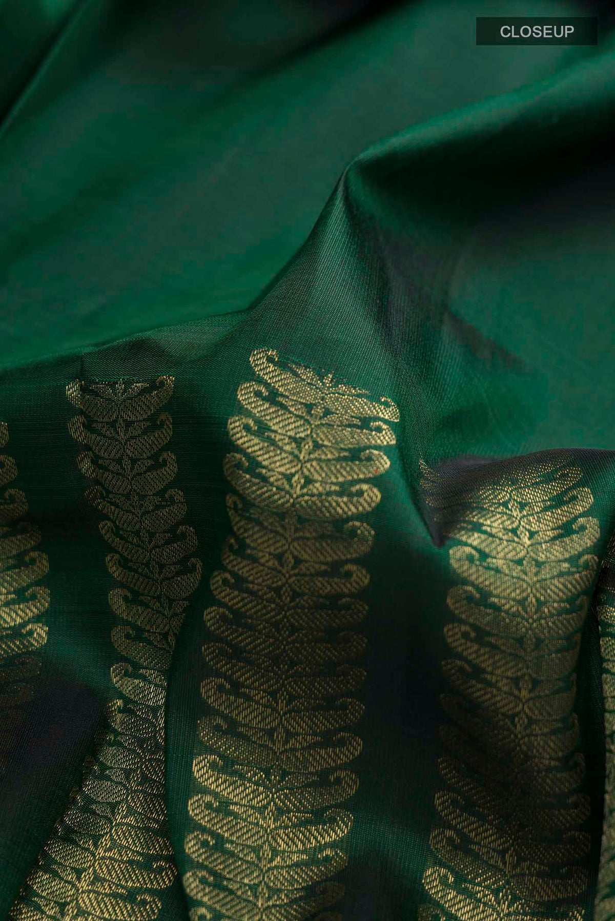 Close up of Green Kanchipuram Silk Saree with Stripes on the body and Without Border displaying folds