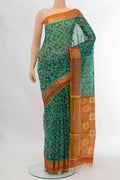 Green Silk Cotton Saree with Ikat design on the body and Zari Border displayed on a mannequin
