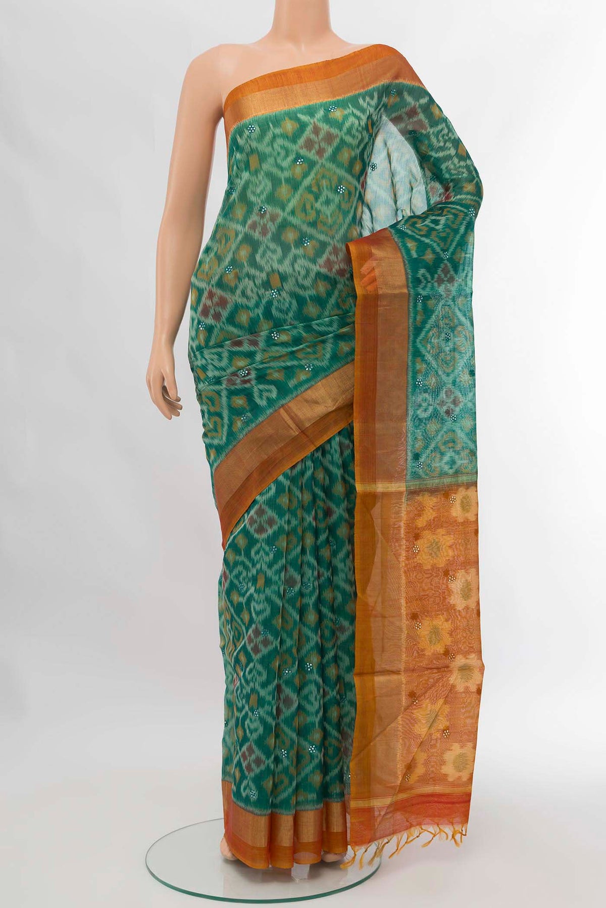 Green Silk Cotton Saree with Ikat design on the body and Zari Border displayed on a mannequin