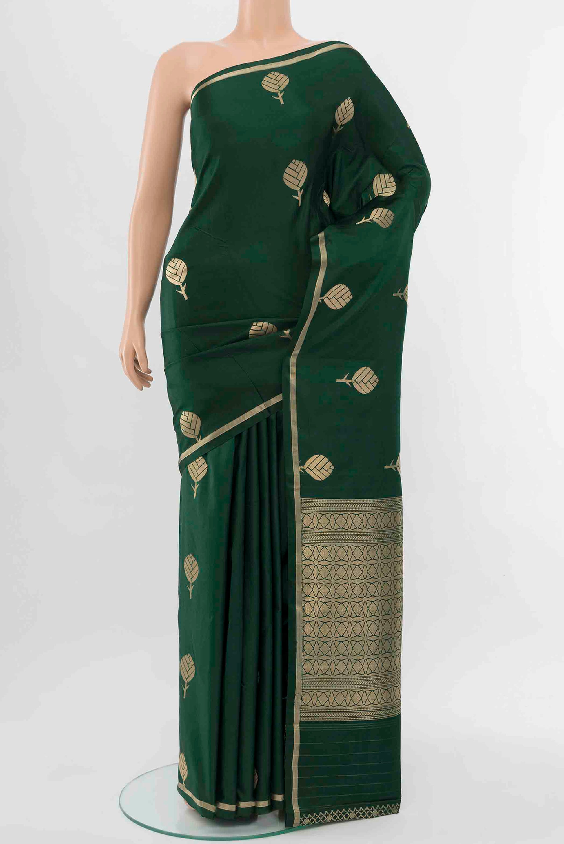 Bottle Green Banarasi Silk Saree with Zari Butta on the body and Thin Zari Line displayed on a mannequin