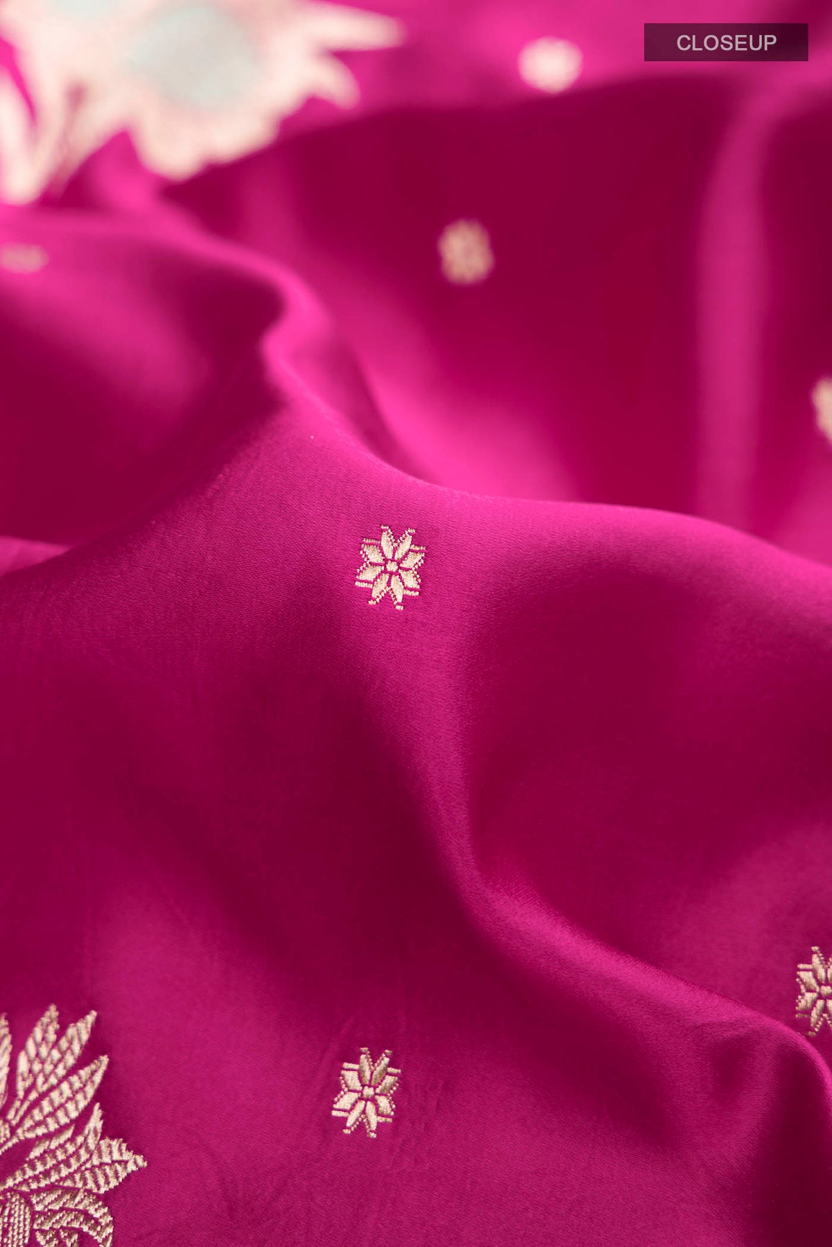 Close up of Pink Banarasi Silk Saree with Zari Butta on the body and Zari Border displaying folds