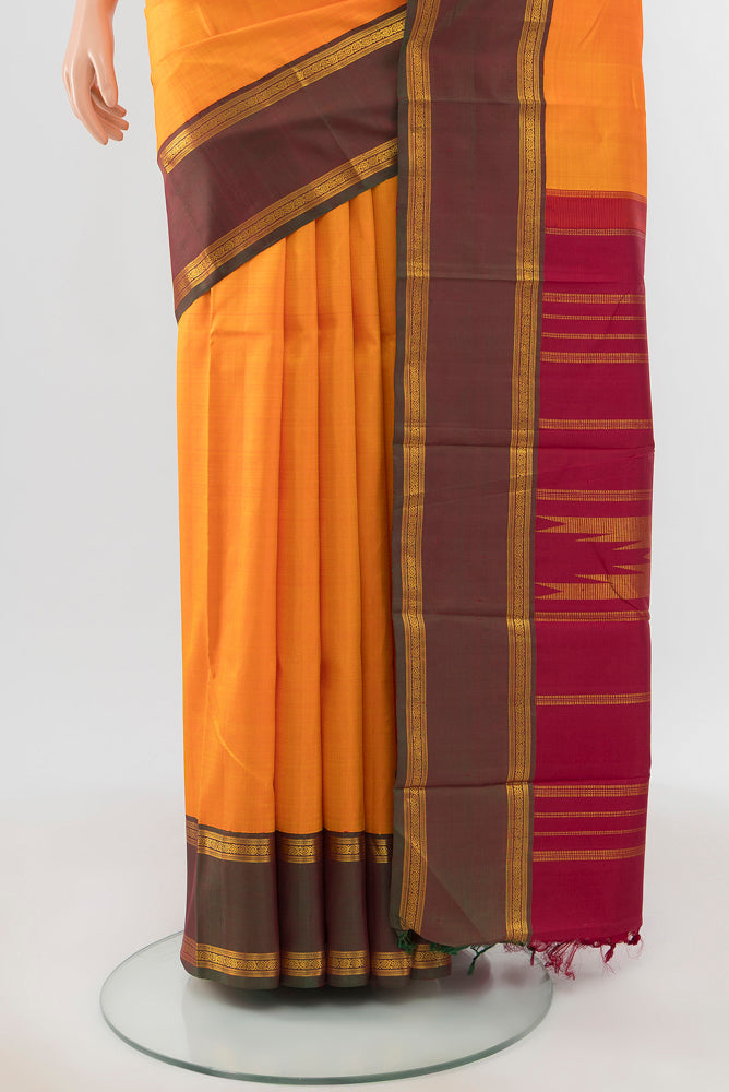 Pleats and pallu of Pure Silk Pure Zari Yellow Kanchipuram Saree with Zari Butta on the body and Silk Border. 