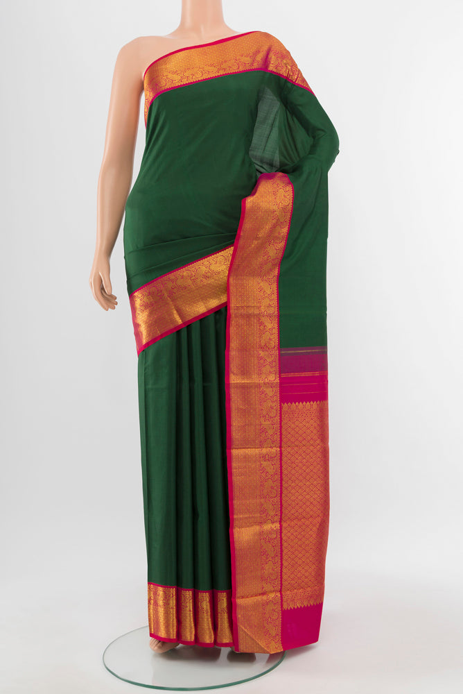 Pure Silk Pure Zari Mint Green Kanjivaram Saree with Zari Butta on the body and Silk Border.  displayed on a mannequin