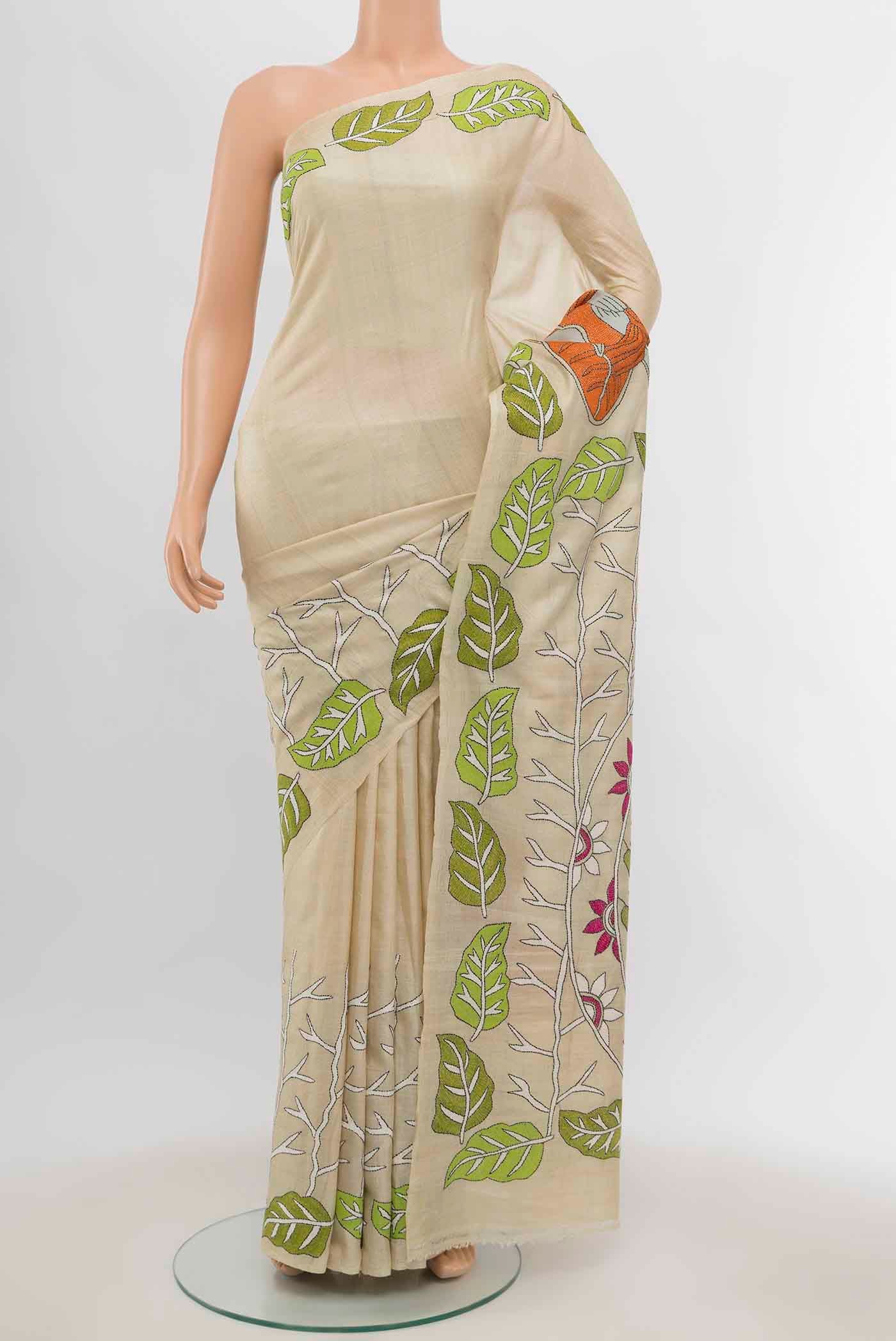 Cream Tussar Silk Saree with Embroidery on the body and Silk Border displayed on a mannequin