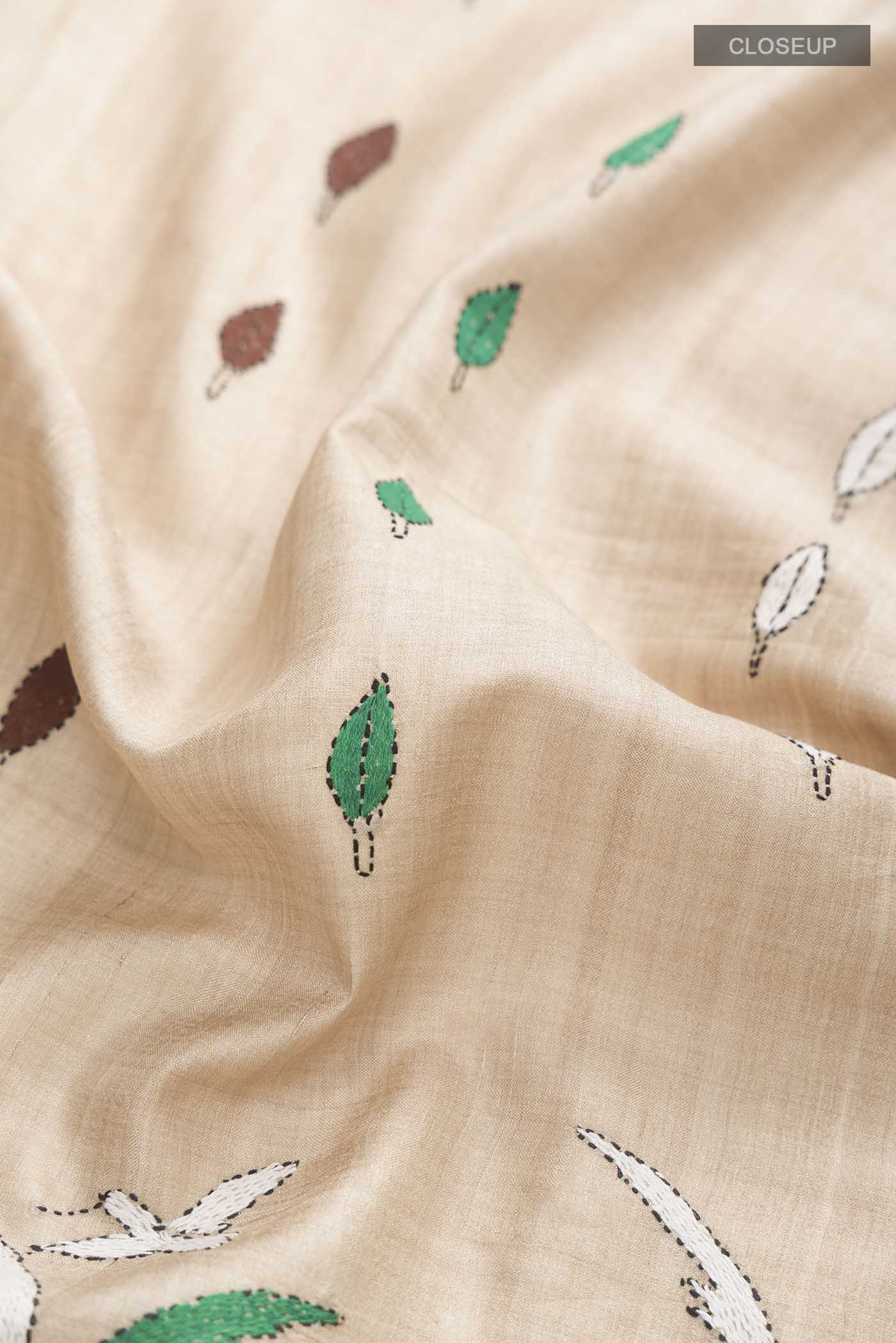 Close up of Beige Bhagalpuri Tussar Silk Saree with Embroidery on the body and Embroidery Border displaying folds