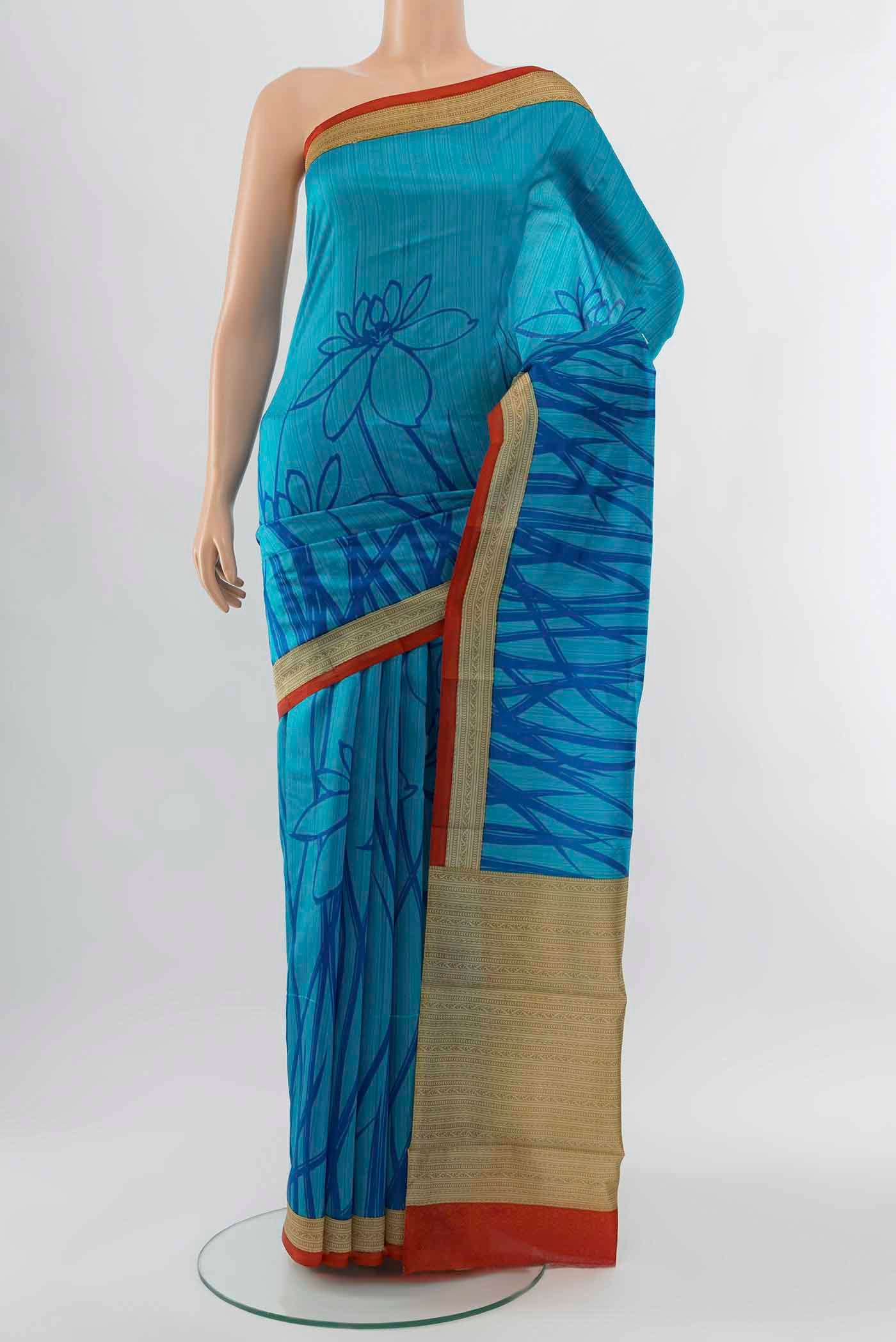 Light Blue Tussar Silk Saree with Floral Print on the body and Silk Border displayed on a mannequin