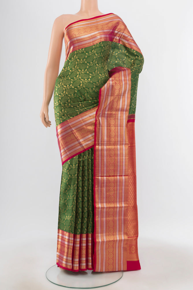 Pure Silk Pure Zari Bottle Green Kanchipuram Saree with Zari Butta on the body and Silk Border.  displayed on a mannequin