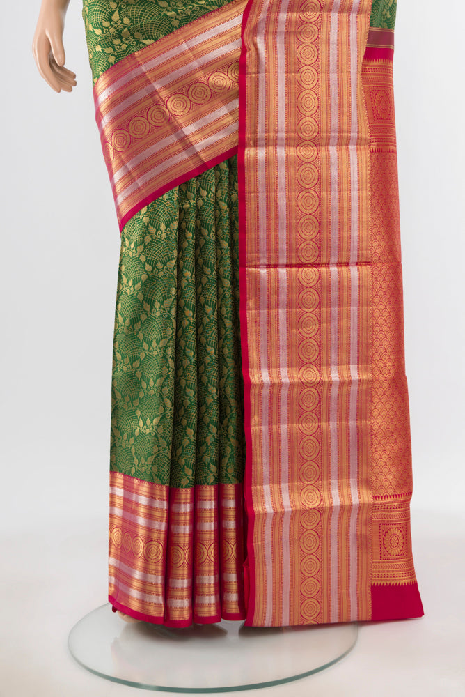 Pleats and pallu of Pure Silk Pure Zari Bottle Green Kanchipuram Saree with Zari Butta on the body and Silk Border. 
