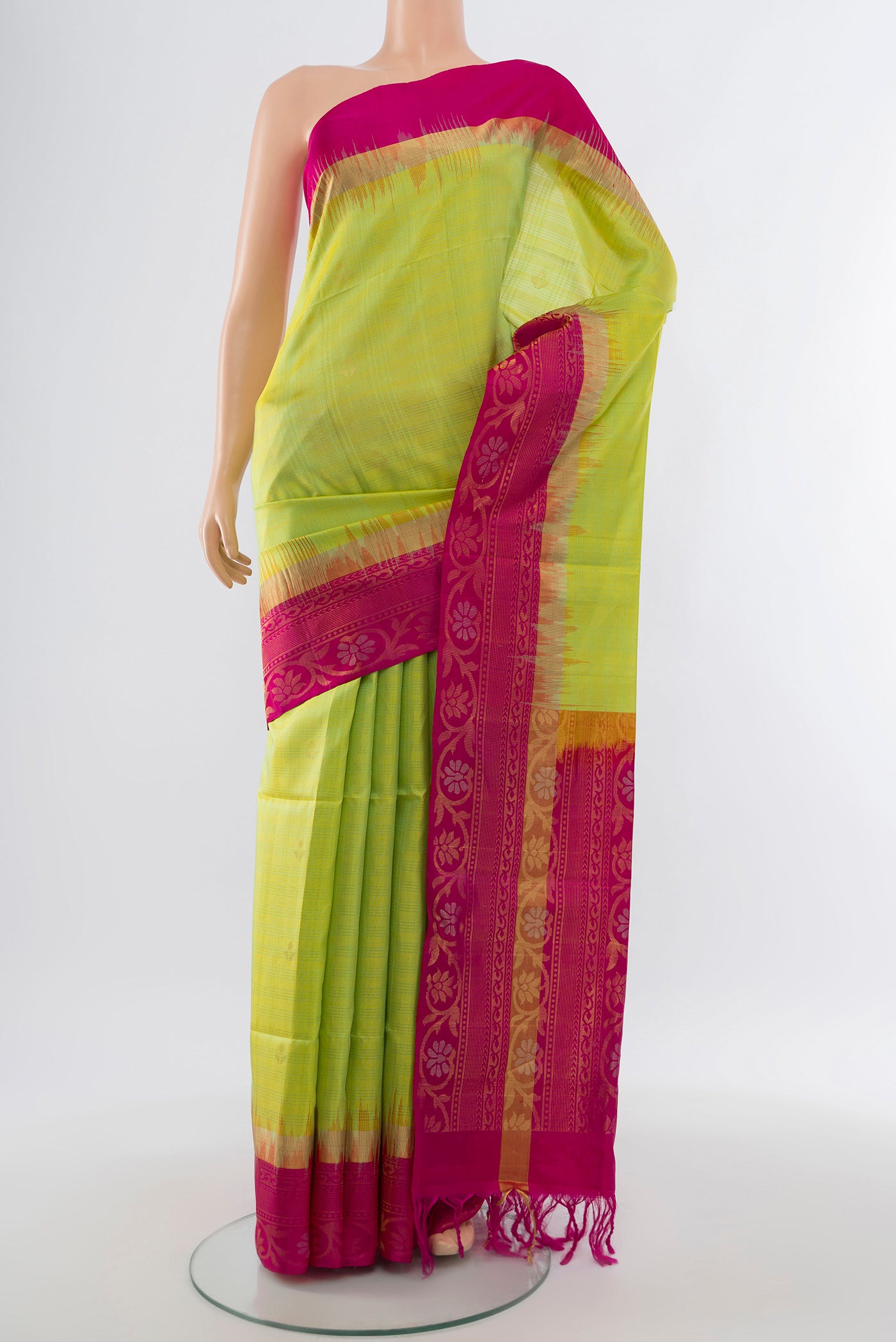 Light Green Soft Silk Saree with Zari Butta on the body and Silk Border.  displayed on a mannequin