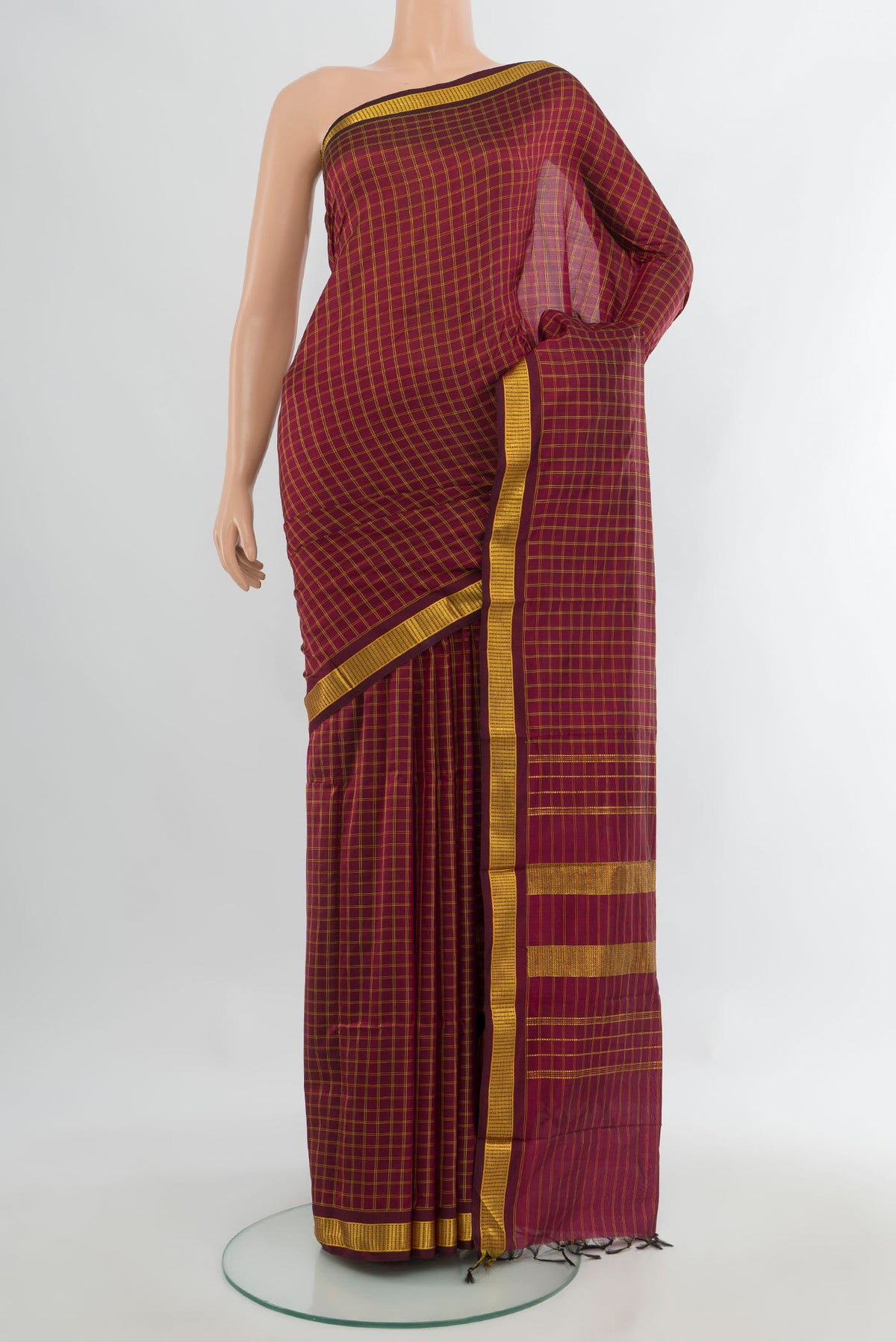 Pure Silk Maroon Kanjivaram Saree with Checked design on the body and Zari Border.  displayed on a mannequin