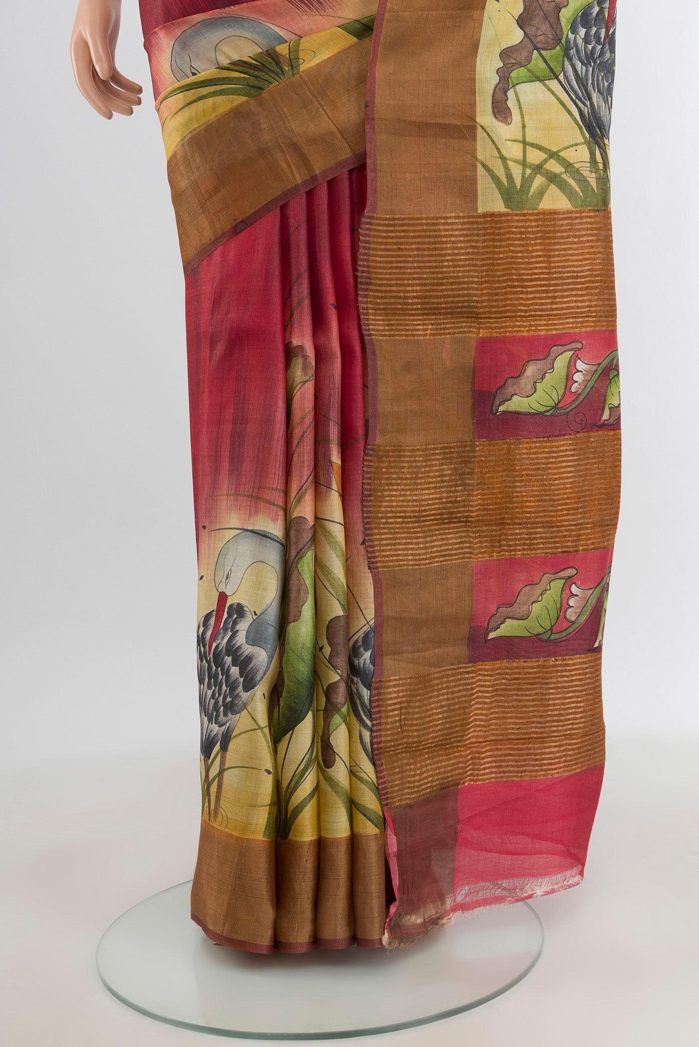 Pleats and pallu of Maroon Tussar Silk Saree with Floral Print on the body and Zari Border. 