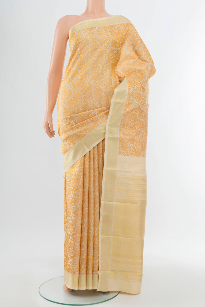 Golden Kanchipuram Silk Saree with Zari Butta on the body and Silk Border.  displayed on a mannequin
