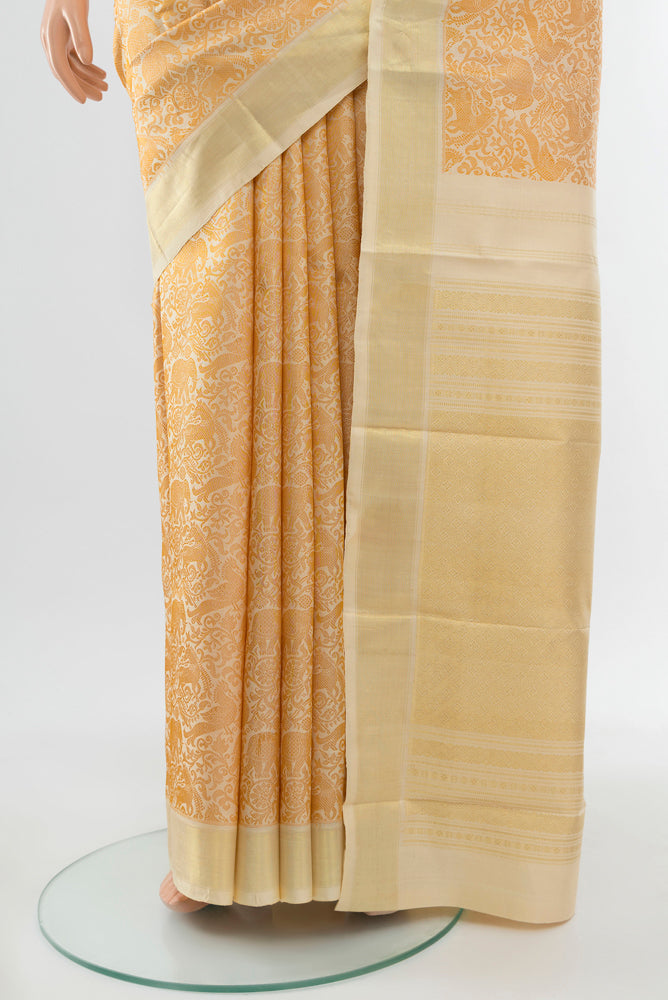 Pleats and pallu of Golden Kanchipuram Silk Saree with Zari Butta on the body and Silk Border. 