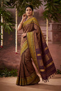 Model wearing a Burgundy Kanchipuram Silk Saree with Zari Brocade on the body and Zari Border.