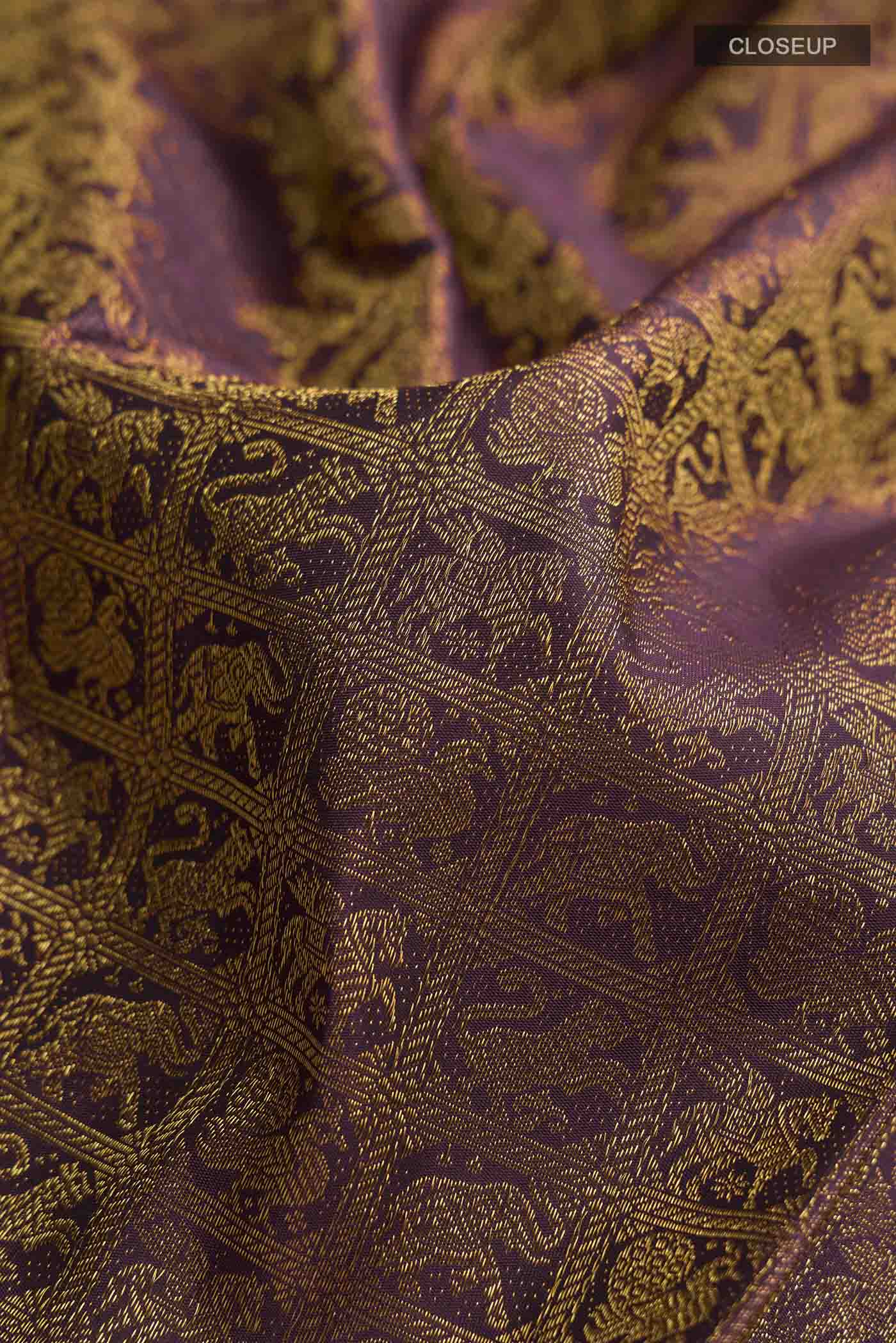 Close up of Burgundy Kanchipuram Silk Saree with Zari Brocade on the body and Zari Border displaying folds