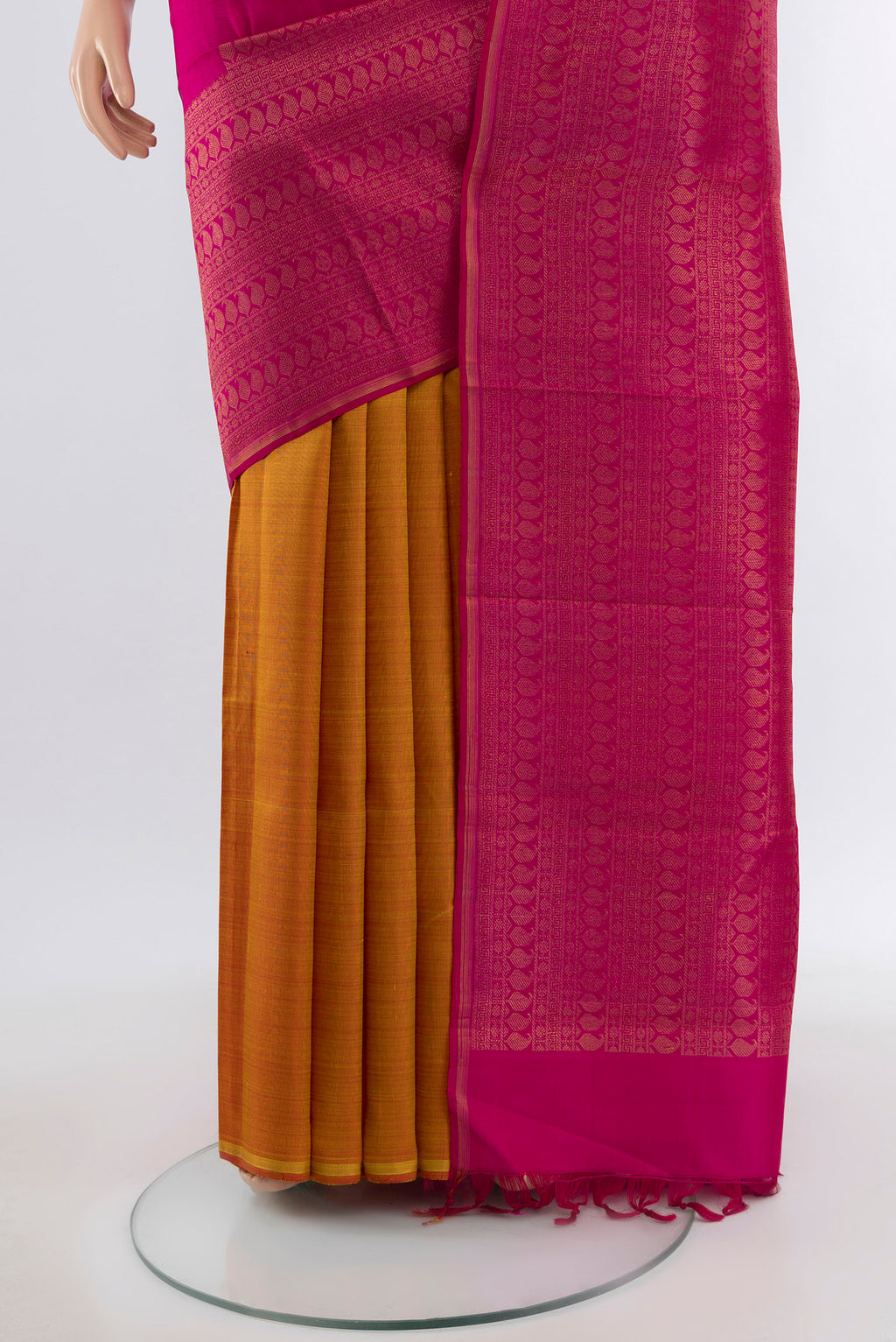 Pleats and pallu of Dark Pink Kanchipuram Silk Saree with Zari Butta on the body and Silk Border. 