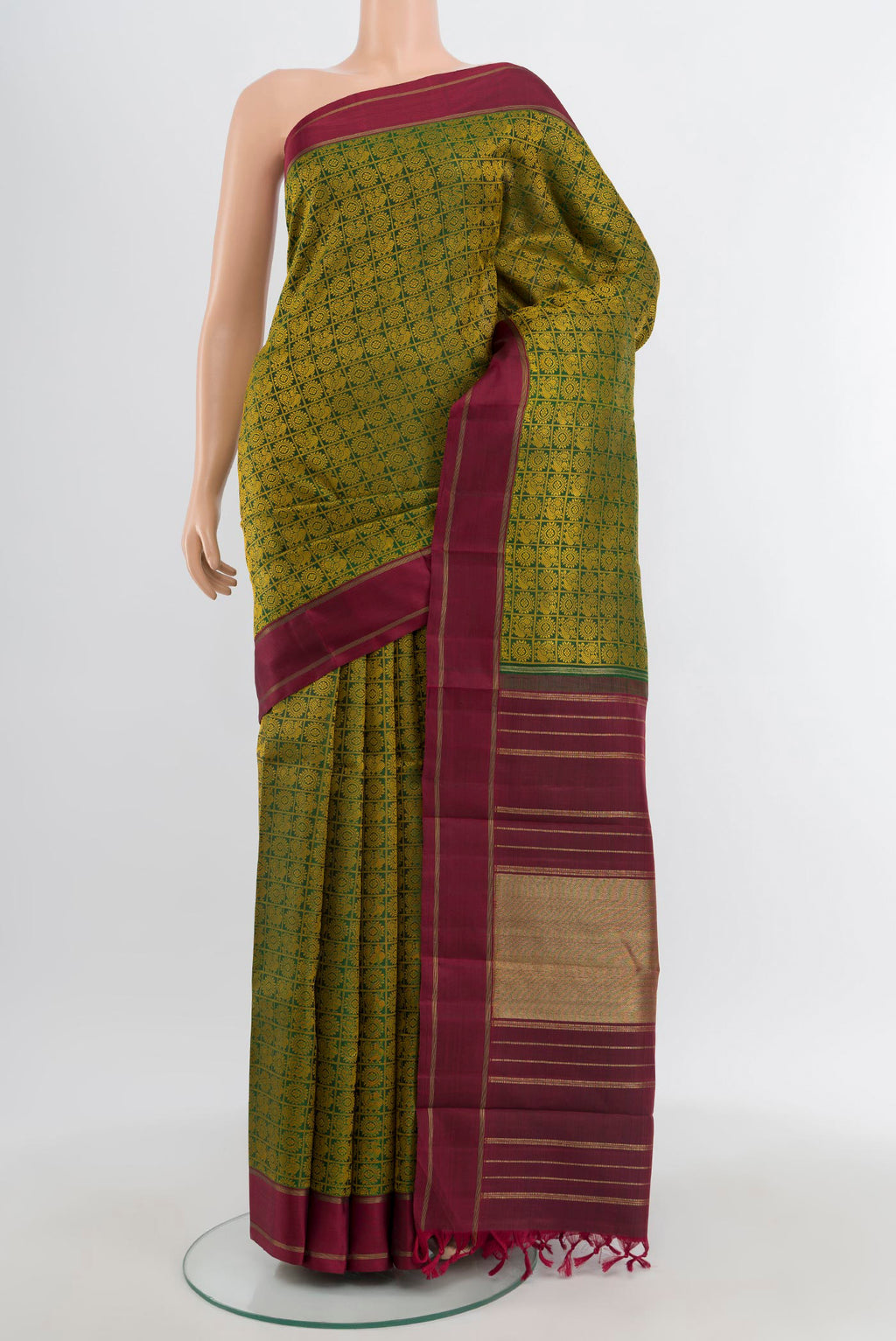 Pure Silk Pure Zari Bottle Green Kanchipuram Saree with Jacquard With Thread Butta on the body and Plain Border.  displayed on a mannequin