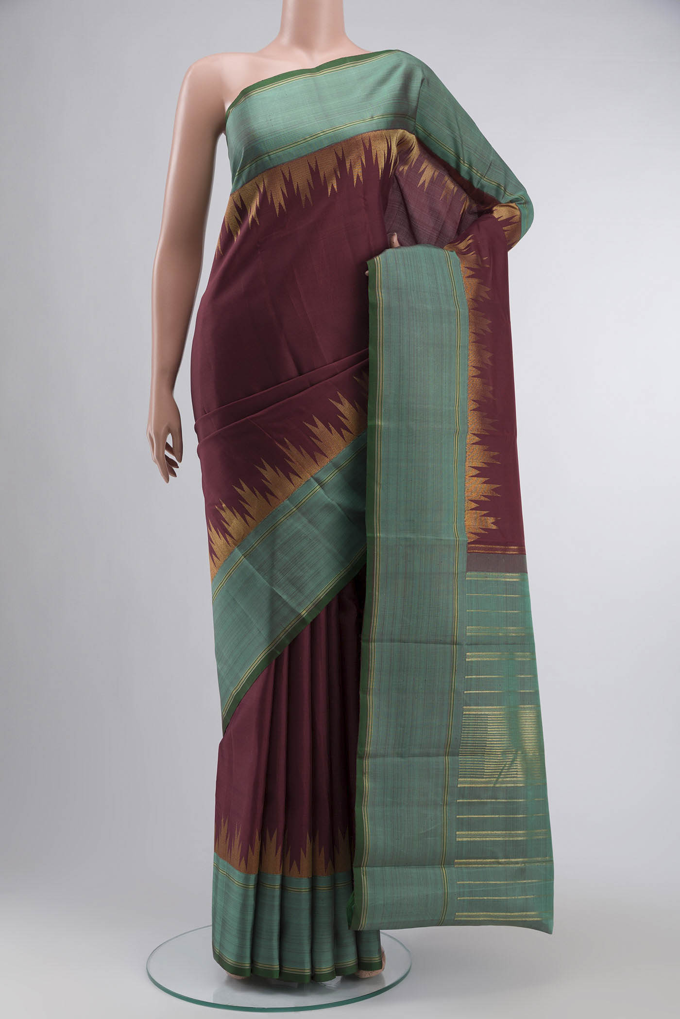 Maroon Kanchipuram Silk Saree with Plain Body and Zari Border displayed on a mannequin
