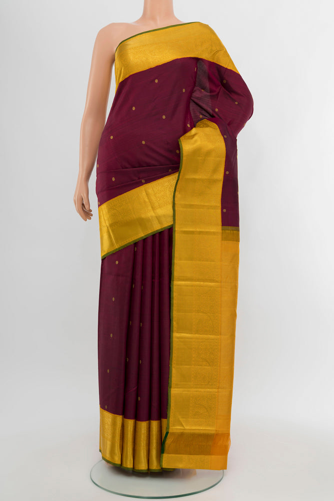 Pure Silk Pure Zari Maroon Kanjivaram Saree with Zari Butta on the body and Silk Border.  displayed on a mannequin