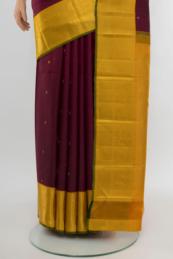 Pleats and pallu of Pure Silk Pure Zari Maroon Kanjivaram Saree with Zari Butta on the body and Silk Border. 