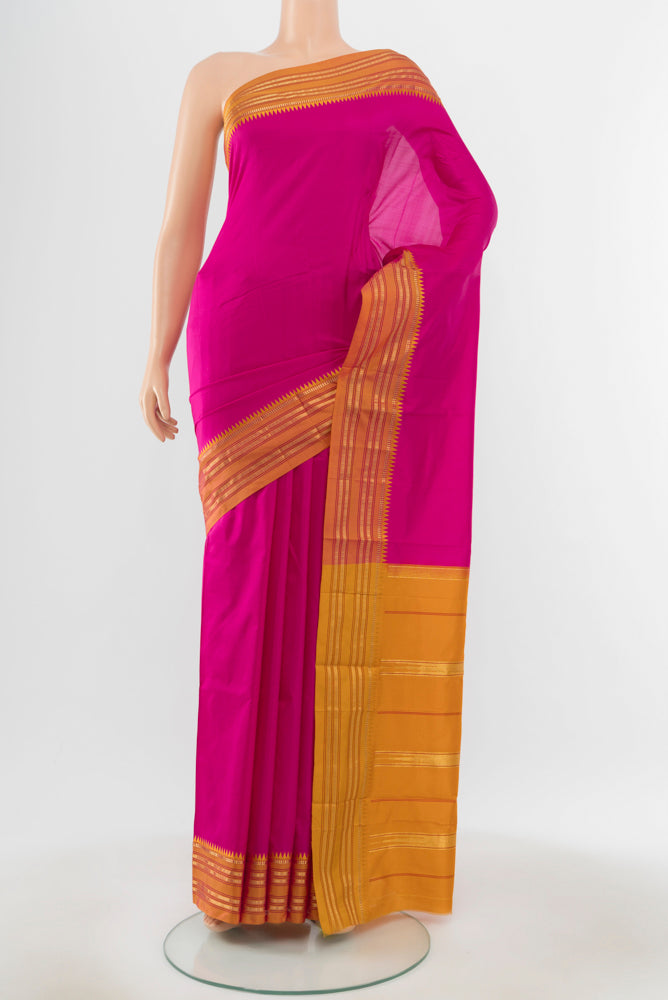 Pure Silk Pure Zari Magenta Narayanpet Saree with Zari Butta on the body and Silk Border.  displayed on a mannequin