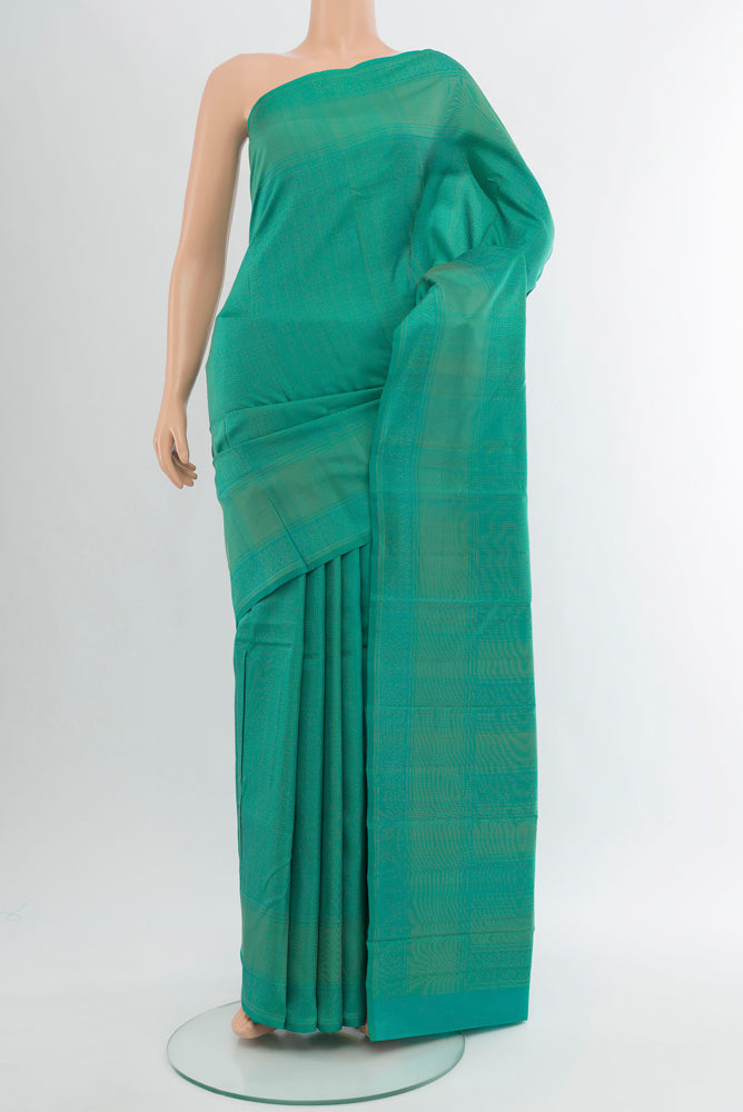 Peacock Blue Soft Silk Saree with Zari Butta on the body and Silk Border.  displayed on a mannequin