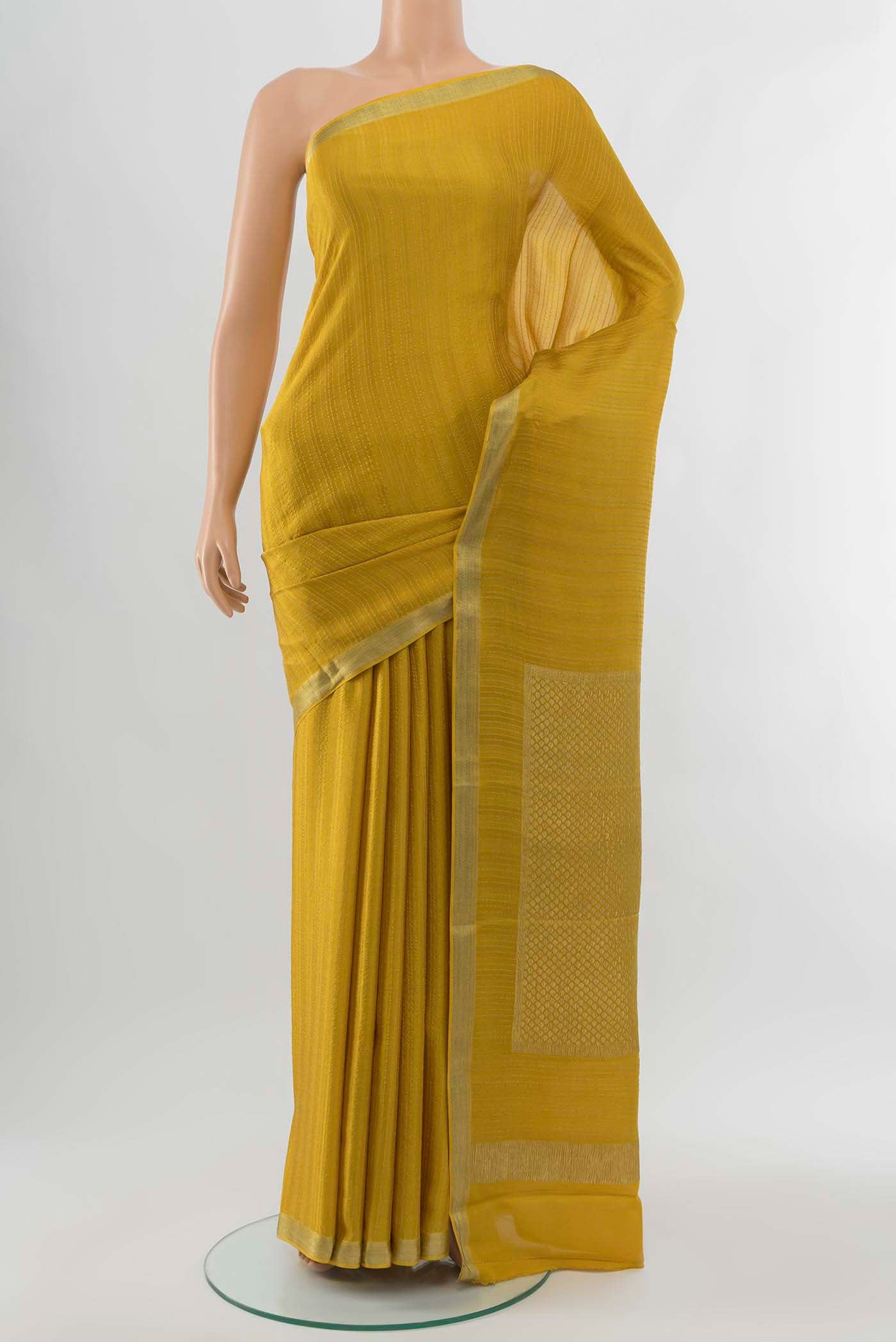 Mehandi Green Georgette Saree with Zari Brocade on the body and Silk Border displayed on a mannequin