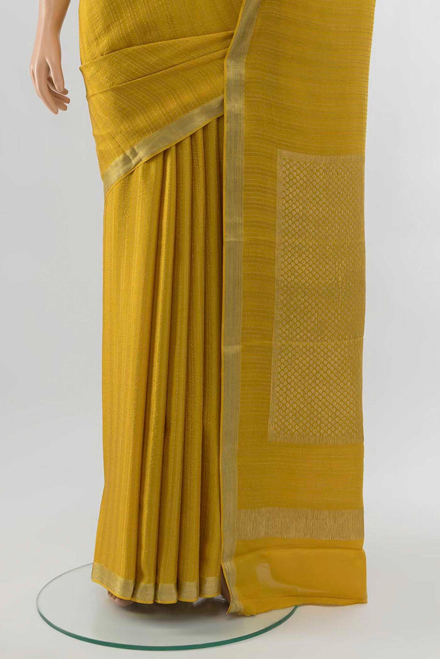 Pleats and pallu of Mehandi Green Georgette Saree with Zari Brocade on the body and Silk Border