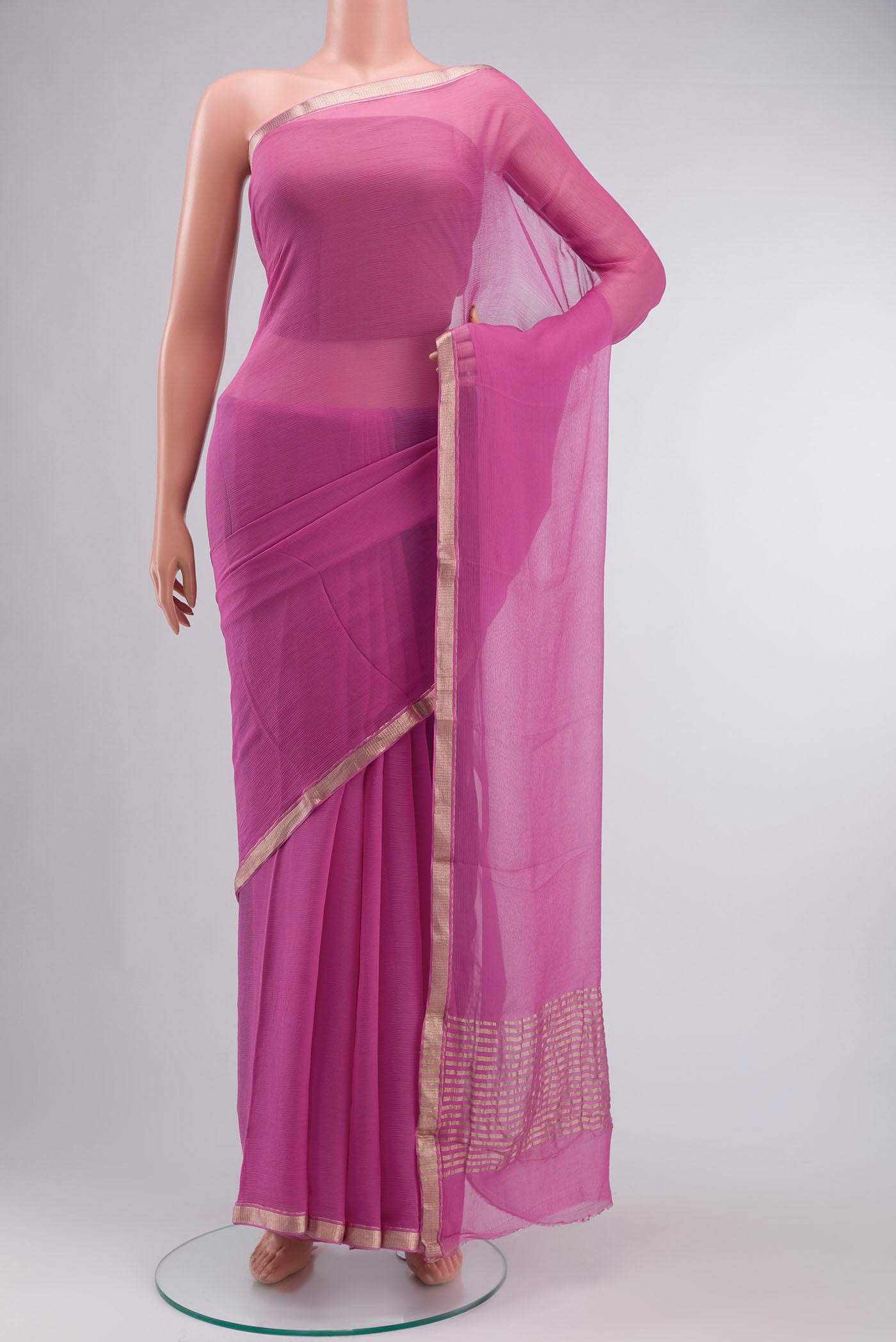 Pink Chiffon Saree with Plain Body and Zari Border displayed on a mannequin